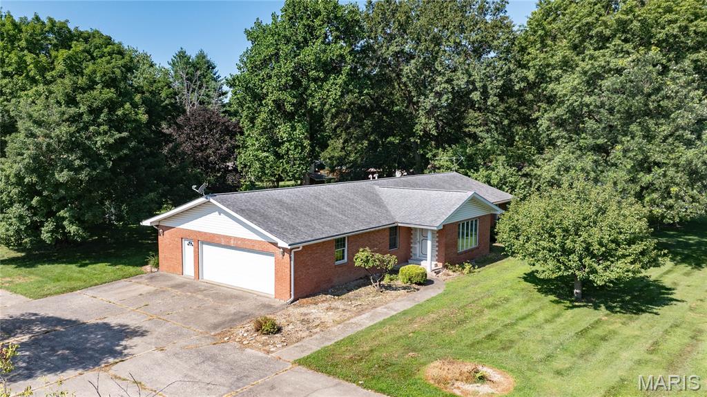 This well-maintained brick home on 1.2 acres offers spacious living with an attached 2-car garage, and a covered front porch that provides welcoming curb appeal. The backyard features a stamped concrete patio, perfect for outdoor entertaining, along with a storage shed. The main level features a welcoming entryway with laminate flooring that opens to a large living room and a separate family room. Sliding glass doors from the family room lead directly to the stamped concrete patio, creating a seamless indoor-outdoor living space. The kitchen offers plenty of storage space and all appliances stay.  Just off the kitchen is a combination walk-in pantry and main-floor laundry room, as well as convenient access to the attached 2-car garage.  The main-floor primary suite features a private full bath. Two additional bedrooms and a second full bathroom complete the main level.  Make your appointment today.