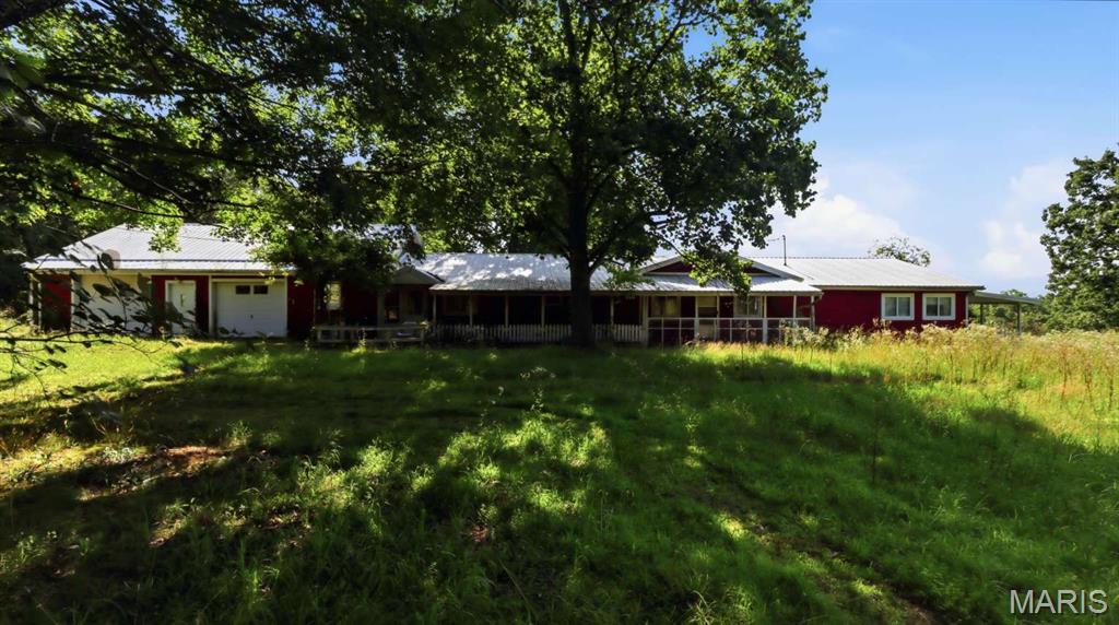 Spacious 5-Bedroom Home on 10 Acres with Pond, Shop & Rental Home | Licking, MO
Discover the possibilities with this spacious 5-bedroom, 4-bath home offering approximately 2,900 square feet of living space on 10 scenic acres in Licking, Missouri. Built in 1975, the property features a durable metal roof installed in 2017, an attached two-car garage, Hardie plank wood siding, a slab foundation, well water, and a septic lagoon.
This versatile property also includes a 1995 single-wide manufactured home featuring 3 bedrooms and 2 bathrooms, which is currently tenant-occupied and generating rental income. In addition, the acreage offers a beautiful pond, a large shop, a pole barn, and livestock pens, making it ideal for those seeking extra space, farming, recreation, or a multi-use investment. Whether you're looking for a private country estate, a property with rental income, or a versatile investment with room to grow, this unique offering combines acreage, multiple structures, and outstanding potential in a peaceful rural setting.