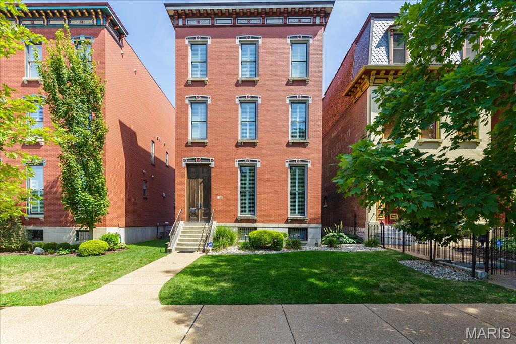 A masterpiece of urban living where modern simplicity meets historic charm, this stunning 3 story home is perfectly situated for relaxed city living, directly across Lafayette Park. Just moments from popular restaurants, vibrant entertainment, and major highways, giving you the best of both worlds—a peaceful retreat that’s still at the center of it all. Upon entry, hardwood floors flow throughout, highlighted by tall ceilings and plantation shutters that add charm and elegance. Formal DR is ideal for hosting dinner parties, while the spacious, light-filled LR invites you to unwind, with easy access to the backyard (entertainer's paradise!), making indoor-outdoor entertaining a breeze. Chef's kitchen: GE Monogram appliances, gas cooktop, and custom walk-in pantry; 1/2 bath is across hall. 2nd flr: The gorgeous primary suite is a spa-like sanctuary with lush new carpet/upgraded pad, gorgeous views, a lux soaking tub, huge walk-in shower, heated floor, and 2 walk-in closets. 2nd bedroom is equally well-appointed, with walk-in closet and full bath.  Laundry room is in between bedrooms. 3rd floor is a space built for fun and relaxation, with rec room/wet bar. A full suite offers a private space for guests. The showstopper is the terrace, an outdoor oasis with an Arch view, offering a truly iconic backdrop for sunset cocktails or morning coffee. Upgrades: sprinkler system, 2nd story HVAC; 2 EV chargers; Sonos sound system.  Full, unfinished, walk-up basement has tons of storage.