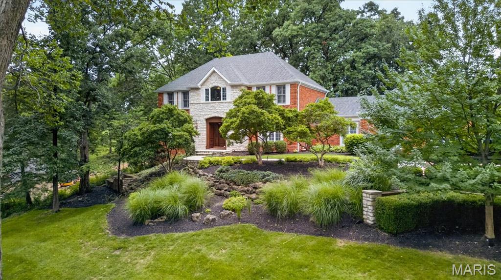 Gracefully perched atop a hill and backing to the 3rd and 4th tees of the Valley Golf Course, this classic Forest Hills brick and stone beauty offers more than 4,500 square feet of beautifully appointed living space.A new flagstone walkway leads to the welcoming entry and a warm, elegant interior featuring hardwood floors throughout the main level and plantation shutters throughout the home. The updated kitchen is the heart of the home, offering abundant cabinetry, a center island, stainless appliances, solid-surface countertops, walk-in pantry, coffee bar, and adjoining breakfast room. Enjoy lovely backyard views, a gazebo and patio, and spectacular sunsets over the Valley Golf Course.The elegant dining room features a beautiful chandelier and large windows, while the spacious, light-filled family room is anchored by a gas fireplace and includes built-in cabinetry, a beverage station, and generous gathering space. A stately wood-paneled office provides a quiet work-from-home retreat, and the screened porch offers a peaceful setting surrounded by trees and hillside breezes.Upstairs, the spacious primary suite includes three walk-in closets and a large bath with double sinks, separate shower, and soaking tub. Three additional bedrooms offer ceiling fans, ample closet space, and access to two additional full baths.The finished walkout lower level is designed for entertaining with a full wet bar, wine refrigerator, game area, abundant storage, and a large TV/relaxation space. Additional features include a main-floor laundry room, two main-floor half baths, two-zone heating and cooling, and a three-car garage with coated concrete flooring.Enjoy an exceptional setting in Forest Hills Club Estates, surrounded by rolling hills, natural beauty, and two golf courses, while remaining convenient to shopping, restaurants, transportation, and highly rated Marquette schools.Included: kitchen refrigerator, washer and dryer, lower-level wine refrigerator, microwave, and mounted primary bath TV. Excluded:  wine refrigerator in family room. Exterior pics and a video to come!