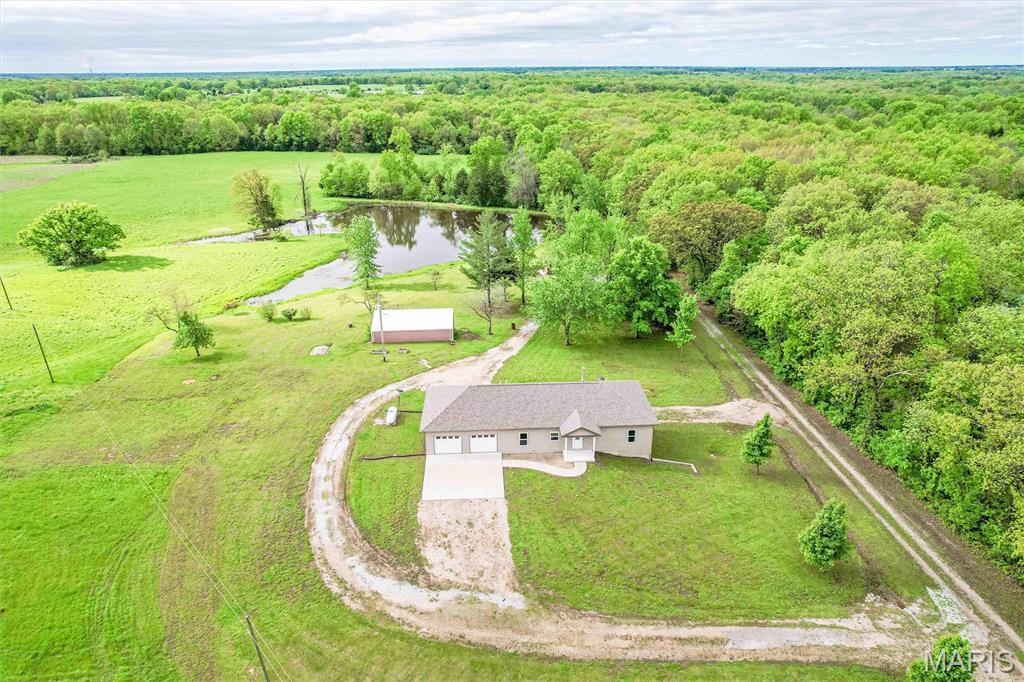 Situated on 20 acres m/l just outside of Auxvasse, this ranch-style home offers the space, flexibility, and convenience many buyers are looking for. The home features: 5 bedrooms, 3 full baths, providing an open layout that can accommodate a variety of living needs with over 2200 sq ft m/l, full basement that is partially finished, along with a 5-car attached/detached garage with openers and is a ‘drive thru’ garage, lake, 16x40 livestock lean-to, 24x36 2 car shop with concrete floor and electric, wooded draw ideal for the recreational hunter and much more. 

The acreage is currently producing hay income of approximately $1,700 per year, offering built-in supplemental income with the option for the next owner to continue the arrangement.
                                                       
The location keeps you connected while still enjoying a more rural setting. You’re approximately 10 to 15 minutes from Walmart and other everyday shopping in Fulton, about 10 minutes to Mosers in Auxvasse and local conveniences, and within 15 to 20 minutes to Hwy 54 and I-70 for an easy commute to surrounding areas. Local employment are also within roughly 15–20 minutes, adding to the overall accessibility of the property and long range ownership.

For those considering employment opportunities, the property is well-positioned with a reasonable drive to major employers in the region. Mexico, MO: home to manufacturing and distribution opportunities such as Spartan Light Metal Products and other industrial employers is approximately 25 to 30 minutes away. The Columbia area, including the Columbia Power Plant and additional employers in energy, healthcare, and education, is within about 30 to 40 minutes, offering a broader range of job options.

This property offers a combination of space, usability, and location—making it a strong option for those looking to balance country living with access to nearby amenities and employment.

Prospective buyers, please ensure you have a preapproval letter or proof of funds ready before scheduling a showing. Buyer to verify all measurements and online data.