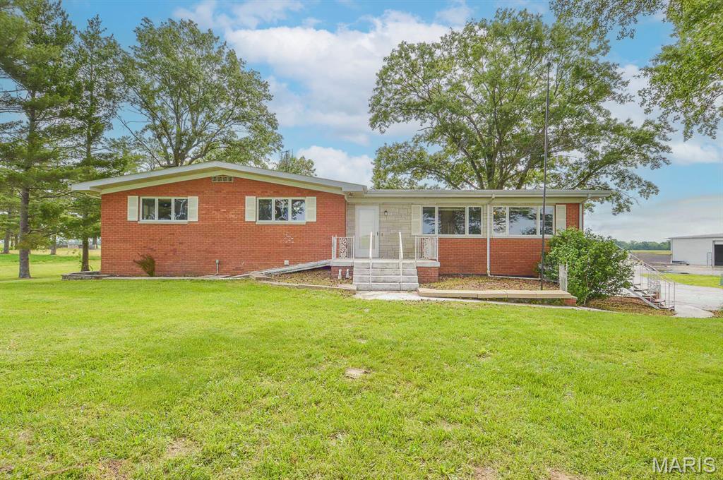 Price listed is Starting Bid Only. Bidding starts closing 07/16/2026 @ 6 p.m. Experience the feel of country living in this beautifully maintained, single owner 3BR/3BA solid brick ranch situated on approximately 4.48 acres in Lenzburg, IL. The home opens to a well appointed kitchen and dining area that leads into a spacious living room overlooking the in ground saltwater pool. A recently updated full bathroom off the main hallway serves two comfortable bedrooms along with an oversized primary bedroom. The full walk out basement significantly expands the living space and features a large recreation room, a cozy family room anchored by a brick mantled wood burning fireplace, a private bar room, a centrally located full bathroom, and an additional three quarter bathroom near the attached garage entrance. Outside, the impressive 60' x 84' concrete block outbuilding offers a large equipment lean to, an open workshop area, a three-quarter bathroom, and a dedicated pool house that services the pool and surrounding brick patio. The expansive acreage provides ample room for recreation, storage, hobbies, or a variety of country living pursuits. Set in a peaceful rural location yet within easy reach of nearby communities and major thoroughfares, this property offers an ideal blend of space, comfort, and country charm. Property will sell under auction terms and be sold AS- IS, WHERE-IS. Seller, will not make any repairs as a result of any building, occupancy, or environmental inspections. Buyer will be required to sign an Auction Purchase & Sale Agreement if final bid is accepted by Sellers.