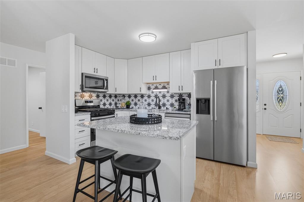 Step inside and fall in love with the brand-new kitchen at the heart of this fully renovated Florissant ranch. Featuring new 42-inch cabinets, granite countertops, stainless steel appliances, and a center island with seating, this kitchen was designed to look as good as it functions.
One of the larger ranch homes in the neighborhood, this property offers a rare 4-bedroom, 2-full-bath layout all on the main level. Beautifully refinished hardwood floors run throughout, complemented by fresh paint, updated bathrooms, new light fixtures, new hardware, and thoughtful updates from top to bottom.The full basement adds even more usable space, including a finished bonus room that works well as a home office, guest space, hobby room, or additional sleeping area. A brand-new electrical panel provides another important update, while the home’s major systems are in good condition.
Outside, you’ll find a fenced backyard and attached 2-car garage, adding both convenience and room to enjoy the property. Located in the established Flamingo Park neighborhood of Florissant, with convenient access to shopping, dining, parks, and major roadways.
Freshly updated, surprisingly spacious, and truly move-in ready, 2125 Crane Drive offers the combination that is hard to find in the area: four main-level bedrooms, two full baths, a completely remodeled kitchen, and additional finished space downstairs.