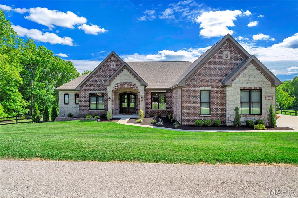 Welcome home to this CUSTOM BUILT 3 BDRM, 3.5 BTH sprawling ranch on RARE 3 acre LEVEL lot in highly sought after Chesterfield location. Surround yourself with scenic serenity as you sit in your MASSIVE screened in patio atop Chesterfield hills and woods. Exterior boasts brick/stone front w/custom arched front door taking you into the jaw dropping interior displaying an open floor plan loaded with personal high end finishes. Some features include: 2x6 construction, double hung windows, 16x32 screened in patio, 10 ft ceilings throughout main, 8 ft Solid Core doors, oversized 3 car garage, irrigation system, wood floors, and more! Entertainer's DREAM kitchen includes massive center island w/breakfast bar, Thermador gas cooktop w/hood, 2 built in ovens, side by side refrigerator, granite countertops & custom tile work. Coffee nook w/built in ice maker. Oversized pantry w/custom shelving. Great room features 12 ft ceilings, wall of windows bringing in TONS of natural light, stone gas fireplace & built ins. Primary bedroom w/coffered ceiling & luxury bath w/his and hers vanities & soaking tub. His and hers closets w/custom shelving. Den/study showcase french doors. HUGE laundry rm w/sink & mudroom. Lower level includes large family/rec room w/walk out, 2 large bedrooms & two full bathrooms w/custom tile in walk in showers. This home truly has it all and is within a 15 minute drive to Chesterfield Valley while allowing the financial benefits of Franklin County! RARE GEM, MUST SEE!