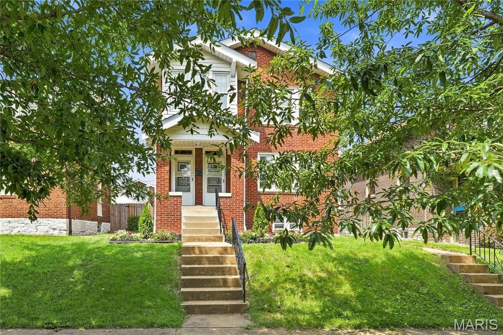 Welcome to 4945 Sutherland Avenue, a charming two-family property offering spacious living, classic St. Louis character and excellent flexibility for an owner-occupant or investor. This well-maintained brick building features a 2-bedroom, 1-bath main-level unit and a 3-bedroom, 1-bath upper-level unit, each with generous room sizes, beautiful hardwood flooring and an abundance of natural light. The main-level unit offers two bedrooms, a full bath, kitchen, separate dining area, spacious living room with fireplace and a bright sunroom. Original hardwood floors and substantial millwork preserve the home's character, while fresh neutral finishes and an updated bath give the space a clean, move-in-ready feel. The upper unit offers three bedrooms and one full bath, along with a kitchen, family room, breakfast/dining area and its own sunroom. The flexible layout provides considerably more living space than typically expected in a multifamily property and makes the upper unit especially appealing for tenants needing an additional bedroom, home office or work-from-home space. 2026 HVAC and Roof with a large, clean unfinished basement provides abundant storage and utility space, while the backyard offers a fenced outdoor area with a fire-pit gathering space. A detached garage adds another desirable feature. With two distinct units, updated interiors, hardwood floors, generous living spaces and classic brick construction, 4945 Sutherland offers an attractive opportunity to live in one unit while generating income from the other, accommodate extended family, or add a versatile multifamily property to an investment portfolio.