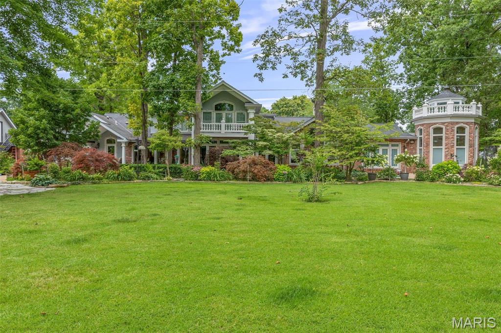 Tucked just outside city limits, this one-of-a-kind estate offers a rare blend of privacy, versatility, and natural beauty.  Set in a quiet, established neighborhood, the property feels like a private sanctuary while being conveniently close to town.  A full commercial-grade greenhouse opens the door to endless possibilities, from hobby growing to a small business. The layout and ambiance also make this property an ideal space for a boutique to large event venue or a high-demand Airbnb destination.  The grounds are truly something special-lush, thoughtfully maintained, and anchored by a stunning waterfall feature that creates a peaceful, retreat-like atmosphere. The home is exceptional. From the beautiful millwork, to the large gathering rooms, including the indoor brick BBQ space and the recreational basement, this home is truly impressive. You'll find generously sized bedrooms and baths providing flexibility for family, guests, or multi generational living. Several rooms have been freshly painted in a clean, neutral palette, creating a bright move-in-ready feel.  The expansive kitchen is a standout feature, equipped with double appliances and dual sinks which is ideal for hosting, catering, or simply making daily life more efficient.  There is a second 3 car garage with one side as workshop and half bath. 
With its size, layout and unique features, this estate offers endless possibilities for customization and or business opportunity.