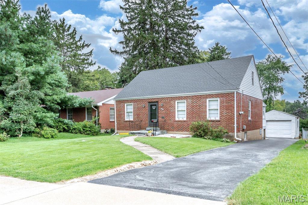Charming, solid, and full of possibility, this classic brick home is ready for its next chapter! Offering 980 square feet of living space, two bedrooms, one full bath, a full basement, one-car garage, and a fenced backyard, this cozy home pairs an easy-to-manage footprint with plenty of opportunity to make it uniquely your own.

Inside, you'll find a comfortable living room, two bedrooms, kitchen, and full bath, with vintage details that give the home a personality all its own. The bathroom features classic colored subway tile—a nostalgic touch that could be embraced as part of the home's vintage character or incorporated beautifully into an updated design.

The kitchen is ready for a fresh vision, offering the next owner an opportunity to reimagine the cabinetry, flooring, and appliances to suit their own taste and style. Update a little at a time, lean into the home's vintage personality, or create something entirely new—the canvas is yours.

Just off the back of the home, an enclosed three-season porch provides an unexpected bonus space overlooking the backyard. Surrounded by windows, it's a charming spot with possibilities for morning coffee, plants, casual seating, reading, or simply enjoying the outdoors with a little extra shelter from the elements.

Downstairs, the unfinished block basement provides valuable additional space for storage, hobbies, a workshop, or future improvements. An existing toilet and potential shower area offer a starting point for additional functionality, while convenient exterior walk-down access from the backyard provides another point of entry to the lower level.

Outside, enjoy a level, fenced backyard with room for pets, gardening, entertaining, or creating your own private outdoor retreat. A driveway and one-car garage add the convenience of off-street parking along with additional storage.

Whether you're a first-time buyer looking for a home you can personalize over time, an investor searching for your next project, or someone who appreciates the charm and character of an older home, there's plenty here to inspire your imagination. With its classic brick exterior, vintage touches, enclosed three-season porch, full basement with exterior access, garage, fenced yard, and manageable footprint, this home offers a wonderful starting point with exciting possibilities ahead.

Property is being sold as-is. Bring your ideas, embrace the character, and imagine what this charming little home could become.