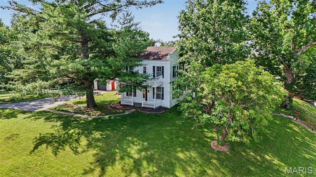 Welcome to 200 Orchard Street! Lots of historic charm here in this 4-bedroom, 1.5 bath, 2-story home nestled on a 1/2 acre corner lot.  Property features a lovely covered front porch. Enter into the living room with updated guest bed to your left.  This room would also make a great office/playroom. Also included on the main floor is the master suite with wood burning fireplace, and full master bath with expanded walk-in closet.  There's also an eat-in kitchen and main floor laundry. The upper level boasts 2 additional bedrooms, a 1/2 bath, and balcony. Enjoy entertaining family and friends on the large patio area and spacious yard. Newer AC installed 8/22. One car detached garage offers up space for storage/and or a workshop area and concrete pad is an added bonus for another garage/storage area.  Own your own piece of New Haven history today!  Being sold "as-is".