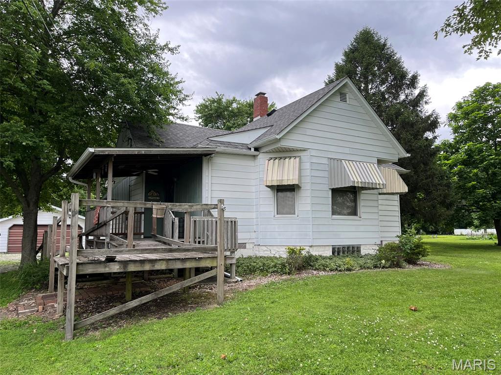 Two bedroom, one full main floor bath home, and a bath with only a shower, and sink in the basement.  Home sits on one acre on Historic Route 66.  Two additional garages, nice size eat in kitchen as well as nice size living room.  Roof on the house was replaced approximately 10 years ago.  Wood burning fireplace in basement.