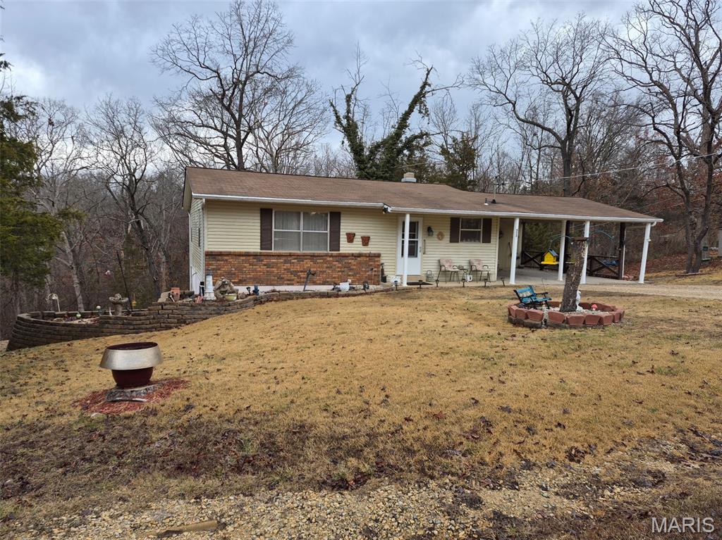 Fantastic 3 bed, 3 bath home in the private community of Terre Du Lac!  Inside you will find this home move in ready.  Spacious floor plan with 1220 sq ft on main level with 2 large bedrooms with new hardwood in master, new countertops in kitchen, and new carpet in bedroom,  a fireplace and sliding door to the rear deck with a view of the woods.  There is an additonal 1020 sq ft of finished living space on lower level with a  3rd bedroom and bathroom, laundry area, a walkout to the the covered porch.  There is a 2 carcarport and dont miss the enclosed 20x 9 enclosed workshop at the rear of carport and  large storage area below.   You can enjoy all that this commuinity has to offer with fishing, boating, swimming, golf, parks and much more.  Just an hour from St Louis you not too far away from anything.