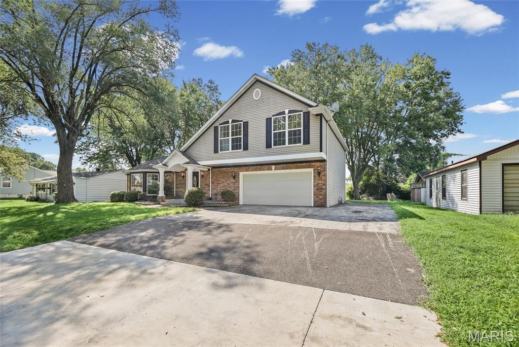Welcome to 210 Stites Avenue, where nearly 3,000 square feet of beautifully refreshed living space meets timeless character and an unforgettable floor plan. Offering 4 bedrooms and 3.5 bathrooms, this impressive Fairview Heights home immediately draws you in with its dramatic curved staircase, abundant natural light and spacious rooms designed for comfortable living and effortless entertaining.

The main level features multiple gathering spaces, an elegant formal dining room and an expansive family room centered around a striking two-sided fireplace with custom built-ins. The generously sized primary suite feels like a private retreat, complete with vaulted ceilings, a private bathroom and French doors opening to its own balcony—the perfect place to begin or end your day.

Recent improvements include fresh interior and exterior paint, updated flooring and carpeting, new light fixtures and ceiling fans, updated kitchen, refreshed landscaping, plus electrical, plumbing and HVAC improvements. Additional highlights include an attached two-car garage, covered front porch, backyard patio, mature shade trees and a 960-square-foot unfinished basement offering abundant storage and exciting possibilities for future use.

Municipal inspection has been completed, and the home is ready for immediate occupancy. With exceptional space, distinctive character and updates already completed, 210 Stites Avenue is a home you need to experience in person. Schedule your private showing today!
All information should be verified by buyer and buyer's agent