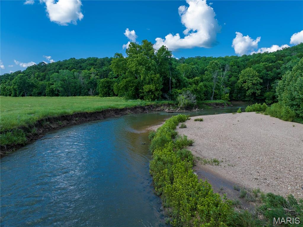 Incredible opportunity to own 66.3+/- acres of highly desirable ground featuring approximately 2,700 feet of frontage on the scenic Wet Glaize Creek. This acreage provides excellent potential for grazing cattle, horses, hay production, or other agricultural uses. Natural beauty, and great hunting or recreational potential. Multiple building sites. A portion of the property borders the Toronto Springs Conservation Area, which adds to the privacy and connects you to almost 900 acres of protected land. Whether you’re looking for a working farm, hunting retreat, or a truly special place to build your future home, this is an incredible setting and a little piece of paradise.