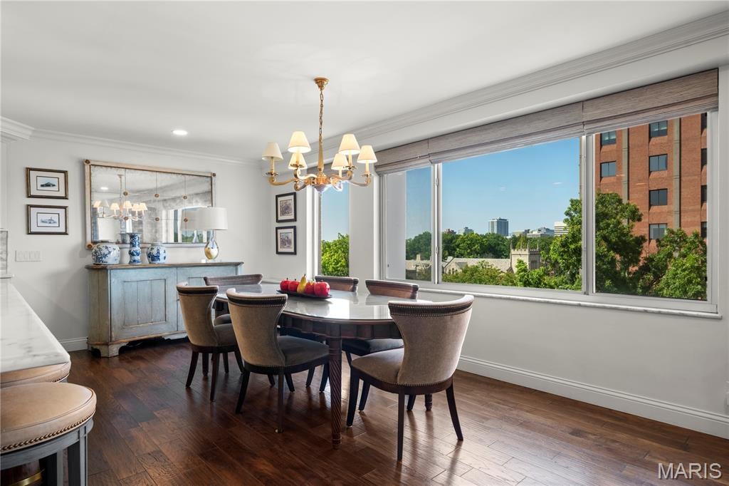 Luxury in the heart of Clayton. Perched above the treetops with sweeping views toward the Clayton skyline, this beautifully renovated residence offers the scale, finishes and full-service lifestyle rarely found at this price point.

Inside, the home has been thoughtfully opened to create a dramatic, light-filled floor plan with seamless flow between the living, dining and kitchen spaces. Hardwood floors, extensive marble, custom built-ins and refined architectural details carry throughout, while two fireplaces add warmth and character, including a private fireplace in the primary suite.

The primary bedroom feels like its own retreat, complete with a cleverly concealed seamless door leading into a custom, spa-like marble bath designed to feel both luxurious and serene. A second expansive bedroom and beautifully updated bath offer equally impressive space and finishes. In-unit laundry adds everyday convenience, and its grandfathered status makes it an especially valuable feature within the building.

Beyond the residence itself, the amenities are exceptional: a doorman, pool, private dog park, fitness space, garage services and beautifully updated common areas create a true full-service condominium experience.

With skyline views, substantial living space, sophisticated renovations and amenities more commonly associated with significantly higher-priced Clayton residences, #6B offers a level of luxury that may be one of Clayton's best-kept secrets.