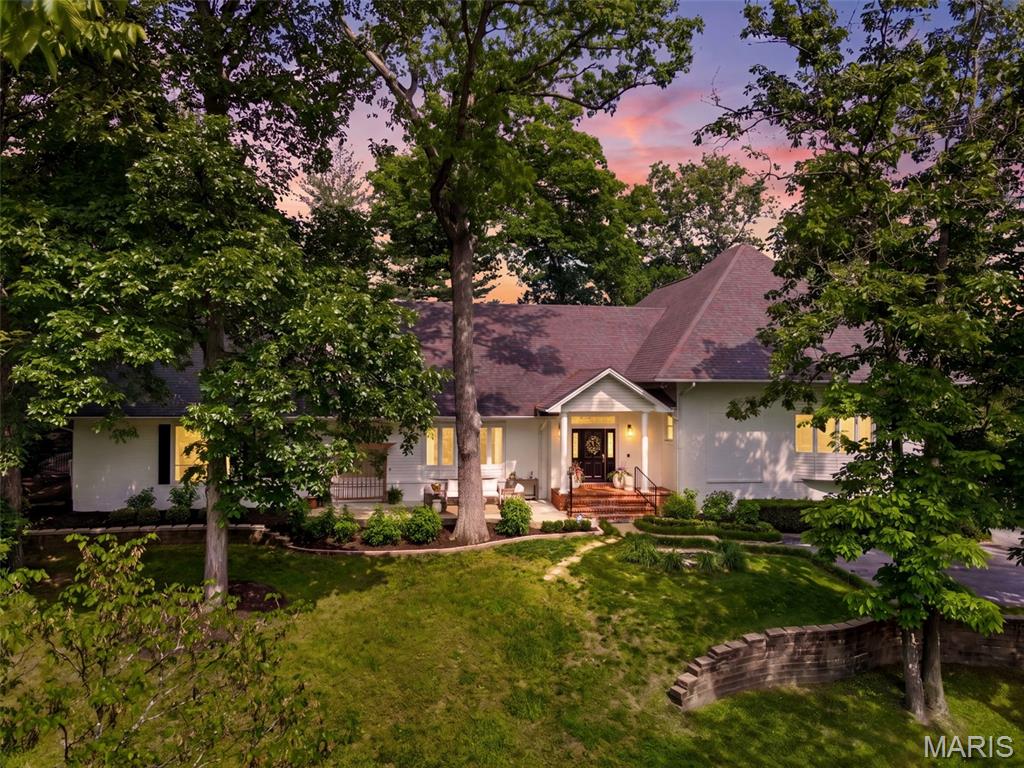 Timeless throughout and reimagined for today, this stunning home has been thoughtfully transformed by its current owner with a designer's eye and an uncompromising standard of finish. Spanning over 5,400 square feet of finished living space, the home pairs its classic architectural character like soaring 9' and 11' ceilings, rich hardwood floors, and sweeping trim and casings, with a fresh, curated aesthetic throughout.
Every room reflects intentional updates: new paint, upgraded fixtures, and refreshed flooring give the interiors a polished, move-in-ready feel. The heart of the home is a spacious kitchen featuring 42" cabinetry, a center island, Quartz countertops, built-in double ovens, and a walk-in pantry. A second family and dining space, highlighted by a stylish bar and wrap around windows, provides ample room for entertaining and family fun. The main-floor Primary Suite is a true retreat, complete with a fireplace, generous walk-in closet, and a spa-inspired bath with dual vanities, a custom walk-in shower, and a dry sauna. Secondary bedrooms are oversized with walk-in closets and well-appointed baths, providing privacy and room for all.
Outside, a newly fenced backyard creates a welcoming space to gather and unwind, complemented by a deck with hot tub, new firepit, updated landscaping and lighting, and a charming bridge at the driveway entry leading to a three car garage. 
Sitting on a park-like setting and located in coveted Town and Country, near top schools, shopping and dining, this is more than a home, it's a lifestyle, beautifully realized.
