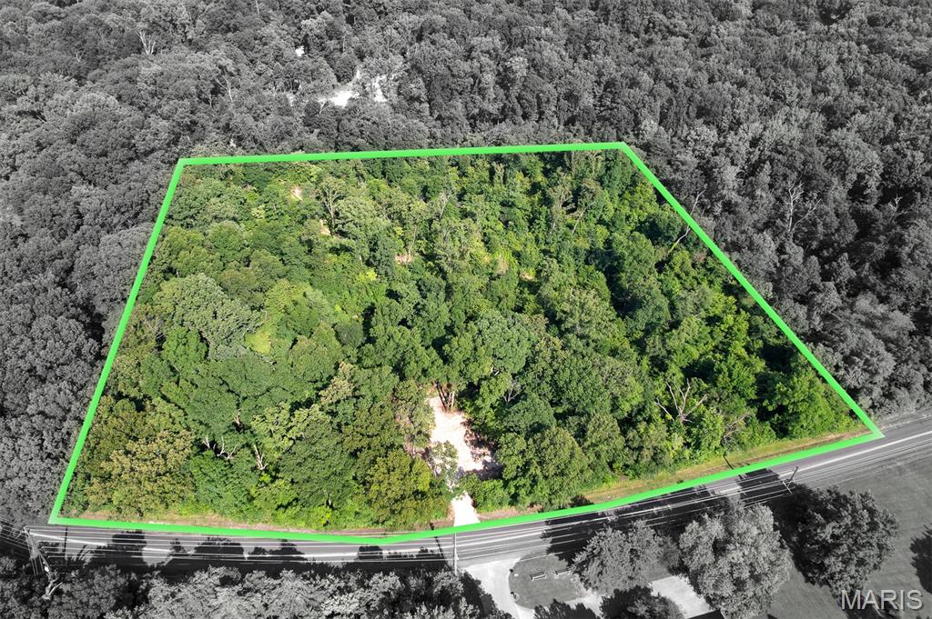 Tract# 2 of this newly split acreage for unrestricted development consists of a 4.33+/- acre timbered building lot with the country feeling of privacy & seclusion.  Located with an entrance off W Cape Rock Rd, this rural timbered land tract is just outside of the Cape Girardeau city limits providing an urban setting.  
With paved road access and electric utility accessible at the roadside, this exclusive lot with private recreational acreage is in a natural state and ready for excavation and construction for whatever a Buyer envisions.  With varying topography throughout, there are also potential areas for a pond excavation.
The wildlife is spectacular throughout this raw land.  This property was once labeled as a deer sanctuary and home to an abundance of whitetail deer and much other wildlife that frequent the area.  
This rarely available property with no deed restrictions places you just minutes from the Downtown Cape Girardeau Riverfront business district, and shopping amenities that the city offers.