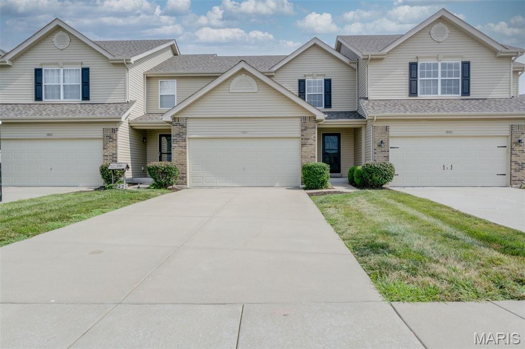 Beautiful Arlington McBride Townhome in the heart of St Peters.  Step inside to see the gorgeous plank wood flooring on the main level continuing thru the great room, breakfast room and kitchen.  There is brand new carpet (July 2026) on the stairs and the upper level plus home is freshly painted. Open floorplan boasts w/ceiling fan in great room & box bay window w/lots of natural light. Fully equipped kitchen w/lots of rich expresso colored cabinets, pantry, black appliances plus the refrigerator is included.  Slider from the breakfast room leads to the patio.  Also on the main level is a convenient guest bath/powder room. Upstairs you find 2 very nice-sized bedrooms both w/ceiling fans, 2 full bathrooms, small loft area that could be a reading nook or computer area.  The owner's suite has a 2 walk-in closets and the secondary bedroom has a walk-in closet as well.  There is a full basement that can be finished for future expansion w/rough-in bath connections & Egress window plus an all electric home.  Attached 2 car garage w/entire roof replaced in Aug 2025 on the building & Association management maintains the outside for a carefree living style plus seller is offering a 1 year home protection plan on the systems & appliances of the home thru HSA. Come see 1844 Sterling Oaks Drive today before the sign says SOLD