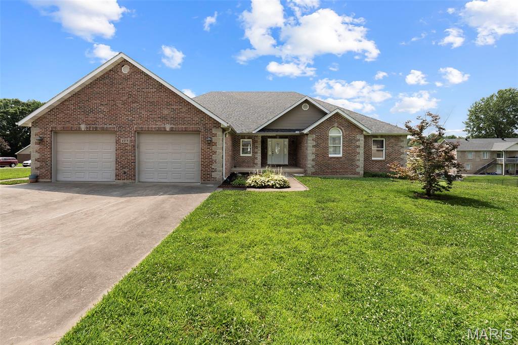 Don't miss this beautiful 3-bedroom, 3-bath all-brick home situated on a spacious corner lot with an additional lot included, offering extra room to enjoy or expand!

Inside, you'll find a welcoming great room with vaulted ceilings, creating an open feel. The kitchen features an island with eat-in dining, making it the perfect gathering space for family and friends. Convenient main-level laundry adds to the home's functionality.

The 3-car garage provides plenty of space for vehicles, tools, and storage. Downstairs, the full walk-out basement offers possibilities for future living space and is ready for the new owner to add finishing touches. The basement already includes a finished full bathroom, abundant storage space, a storm cellar, and a John Deere room with double-door access.

With solid brick construction, extra land, and room to customize, this home offers the perfect combination of comfort, space, and potential. Schedule your showing today!