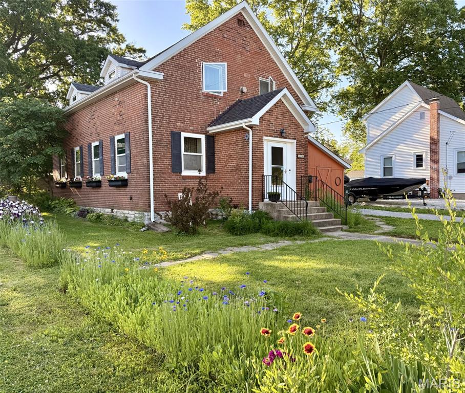 Enter a piece of Waterloo history with this charming 3-bedroom, 2-bath brick home, originally built in 1907 as the first Lutheran Church in Waterloo. Rich with character and timeless appeal, this unique property beautifully blends historic charm with modern updates for comfortable everyday living. 
Inside, you'll find spacious rooms, warm character, and thoughtful improvements throughout. The large upstairs bedrooms each feature three closets and stunning original hardwood flooring, offering both charm and exceptional storage. Over the past 10-15 years, many major updates have been completed, including wiring, HVAC, windows, roof, drywall, doors, kitchen, flooring, and bathrooms - giving peace of mind while preserving the home's historic integrity. 
Enjoy mornings in the beautiful garden and patio area, perfect for relaxing or entertaining guests. The attached 10x20 storage area provides excellent additional space for hobbies, tools, or seasonal items. Conveniently located near downtown Waterloo, restaurants, and local shops, this one-of-a-kind property offers small-town living with history, character, and convenience all in one. 
A/V recording on premises (Ring doorbell)