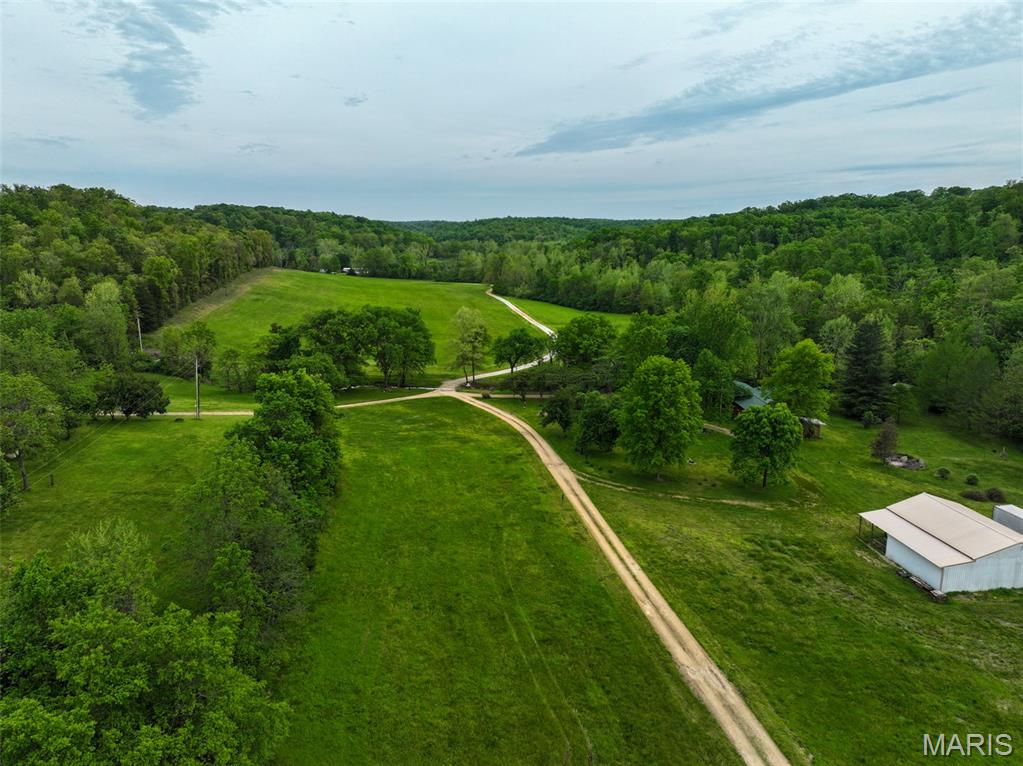 Opportunities to own a truly complete Ozark property in Franklin County are becoming increasingly rare, and this exceptional 78 acre recreational and residential property delivers everything buyers are searching for in today’s land market. Located at 4079 Highway K just outside Sullivan, this turn-key country retreat combines a charming manufactured home, multiple outbuildings, live water, mature hardwood timber, productive pasture, outstanding hunting opportunities, and immediate access to some of eastern Missouri’s most sought-after outdoor destinations.
Positioned in a scenic creek valley in the heart of the Missouri Ozarks, this property consists of two parcels totaling approximately 78 acres and offers an ideal blend of recreation, functionality, and long-term investment appeal. A private drive leads you into a picturesque setting where a charming country home is tucked into the valley floor, surrounded by timber, open pasture, and the peaceful sounds of flowing water. The setting is exactly what buyers envision when searching for Missouri recreational land with a home, live water acreage, or a private hunting retreat.
One of the defining features of this Franklin County property is beautiful Brush Creek, a tree-lined live-water creek that flows through the farm, creating year-round beauty, dependable wildlife habitat, and a natural corridor for deer and turkey movement. A natural spring adds another valuable water source, enhancing the property's functionality for wildlife and livestock. Brush Creek joins the Meramec River less than a mile away, placing some of Missouri’s most recognized floating, fishing, and recreational waters just moments away via Meramec State Park.
The land offers exceptional diversity. Approximately 56 acres are covered in mature Ozark timber, creating bedding cover, mast production, and natural travel corridors for wildlife. Rolling ridges transition into draws, creek bottoms, and edge habitat that serious hunters seek. Approximately 20 acres of pasture provide versatility for horses, livestock, food plots, hay production, or expanded recreational development.
For hunters, this property sits in an area known for exceptional whitetail deer and turkey hunting. The combination of live water, hardwood ridges, edge habitat, and access to public ground creates year-round wildlife movement. Even more attractive, the property directly adjoins Little Indian Creek Conservation Area, giving direct access to additional acreage for hunting, hiking, and exploration.
Outdoor recreation extends far beyond the property lines. Meramec State Park, Meramec Conservation Area, Pea Ridge Conservation Area, and sections of Mark Twain National Forest are all nearby. Multiple outbuildings provide storage, workshop space, equipment housing, hobby opportunities, and future customization. Three wells are strategically located across the property, providing reliable water sources that add long-term utility and flexibility for residential, agricultural, or recreational use. A historic house adds character and additional possibilities. Despite its peaceful setting, the property offers convenient access from Highway K and is just minutes from Sullivan and St. Clair.
Whether you are searching for Missouri hunting land for sale, a live-water farm in the Ozarks, a private retreat, weekend escape, or legacy property, this Franklin County offering checks all the boxes. Properties with this combination of live water, mature timber, pasture, improvements, public land access, and an established residential setting rarely reach the open market.