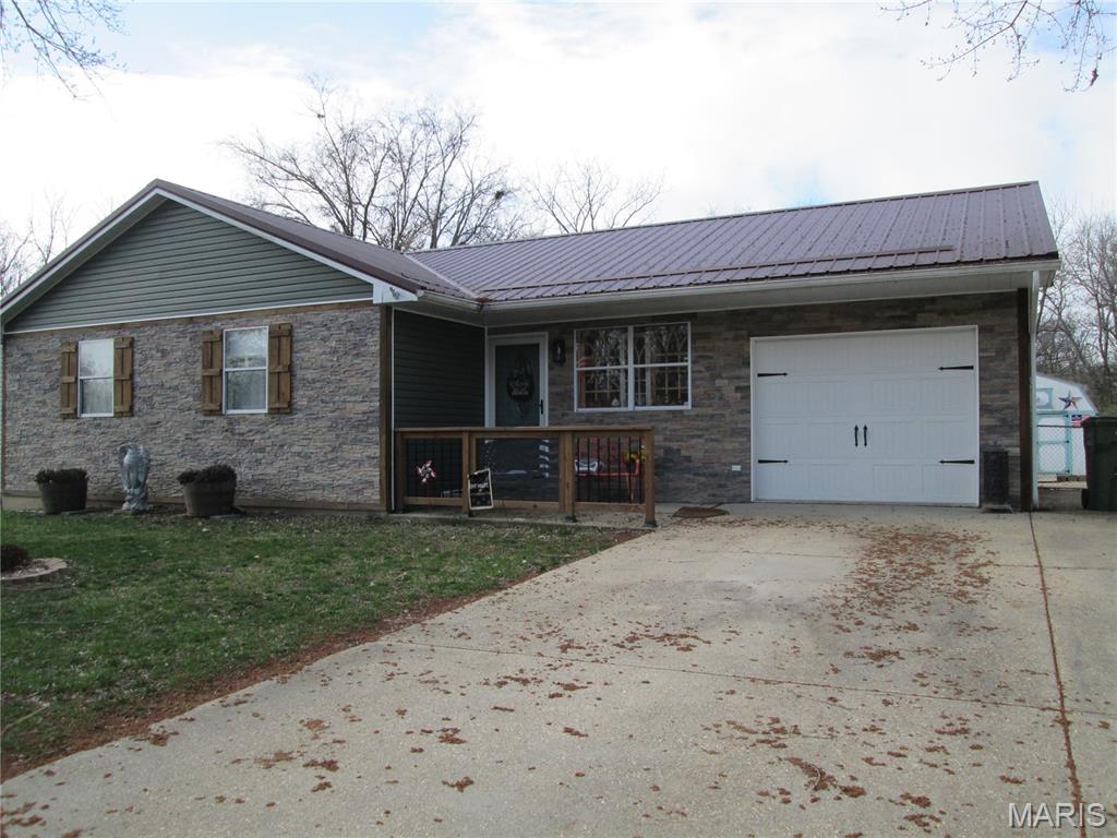 This beautiful home has had so many updates : New Metal Roof, new rock and vinyl siding, new HVAC, new range and dishwasher. All those expensive items are covered!!! The home has been well cared for. Has huge eat in kitchen with lots of cabinets. Washer and dryer stays. Back yard is fenced and has a great fire pit area, also 9 x 16 covered deck freshly painted. For the guys a great 32 x 11 workshop with loft areas, heat, air conditioning and TV. Super long driveway next to house for extra parking. House is in flood plain but never has flooded.  Come check this out.