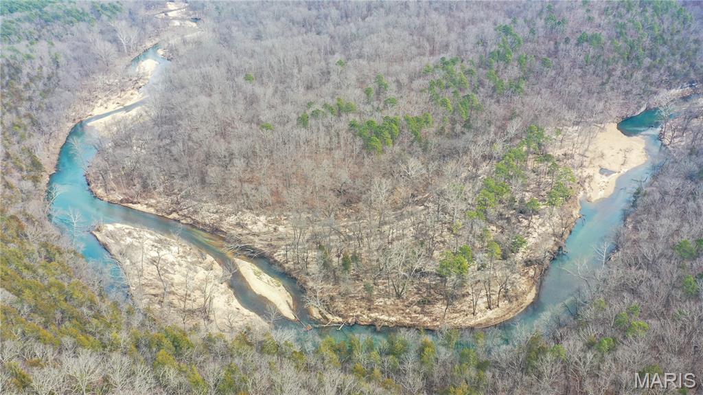 A truly rare generational offering in the Missouri Ozark Mountains on the Current River - this approximately 440 acre private estate along the Current River is being offered for the first time in over 64 years. Spanning approximately 1.5+ miles along both sides of the river, this is an exceptionally scarce opportunity to control a meaningful stretch of one of Missouri's most iconic waterways. The land remains largely untouched, preserving its natural character and rich history. Surrounded in part by federally and state-protected lands, the property benefits from a level of privacy and permanence that is increasingly difficult to replicate. Approximately 360 acres are protected under a conservation easement Public Law 88-492 established the first Federally protected river system , ensuring long-term preservation of the landscape, while approximately 80 acres remain unrestricted - providing valuable flexibility for development, including a private lodge, estate compound, or eco-tourism concept. Two main roads lead to the north and south entrances. Electricity on the property. Approximately 17 miles to Salem Missouri for shopping nearby yet you have complete privacy on this property with no one in sight.  This is more than land - it is a private riverfront estate, a legacy holding, and a rare opportunity to secure a significant piece of the Ozark Mountains. Inquire for maps, aerials and a private tour.  This property is owned by members in the same family and being sold as one estate/large property with development possibilities.  This land can be farmed, great for hunting and horse back riding, exploring nature. The land can be divided into smaller parcels with the Park Service approval. This is a duplicate listing of MLS#26023966.