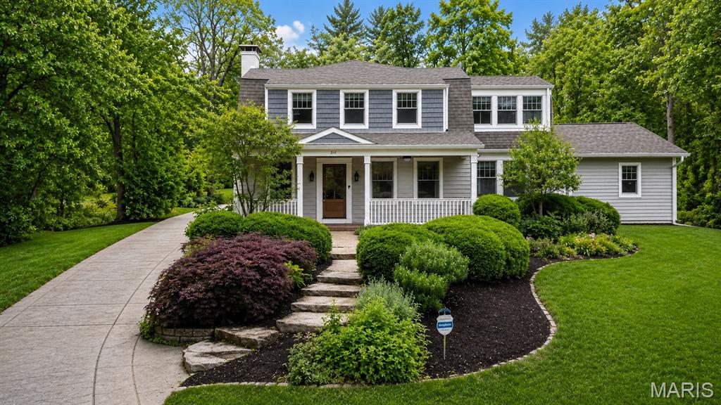 Nestled back on a large lot in the highly sought-after Webster Park neighborhood, this 2-story home blends timeless charm with modern luxury just minutes from the boutiques, restaurants, and coffee shops of downtown Webster Groves. All while also offering 4 bedrooms, 3.5 baths, and 3,334 square feet!  The stunning outdoor living space is designed for year-round enjoyment with a covered patio featuring four recessed ceiling heaters, tongue-and-groove cypress ceiling, stamped concrete patio, and illuminated retaining walls overlooking the beautifully landscaped yard. Inside, refinished hardwood floors flow throughout the main level including the office, living room, and dining room highlighted by crown molding and an immense amount of natural light. The beautifully updated kitchen opens seamlessly to the family room with floor-to-ceiling built-ins and a gas fireplace, and features quartz waterfall countertops, custom hood and backsplash, a butlers pantry perfect for a beverage center, a 30” Wolf dual-fuel range and a walk in custom pantry. The spacious main-floor primary suite addition offers a true retreat with heated bathroom floors, dual sinks, bidet, oversized walk-in shower with dual shower heads and body jets. You will also find a mudroom and laundry room with easy access to the primary and living areas. Upstairs, a spindled staircase leads to a second primary suite with vaulted ceilings, a spacious bathroom with dual vanities, shower, soaking tub and a second laundry area. Two additional bedrooms, a sunroom perfect for a playroom and a hall bath complete the 2nd floor. This exceptional property also features a rare 4-car tandem garage with epoxied floors, HVAC, and copper overhang. Additional highlights include newer Andersen windows, insulated siding, gorgeous curb appeal with an oversized stamped driveway & porch with tongue-and-groove cypress ceilings and much more!