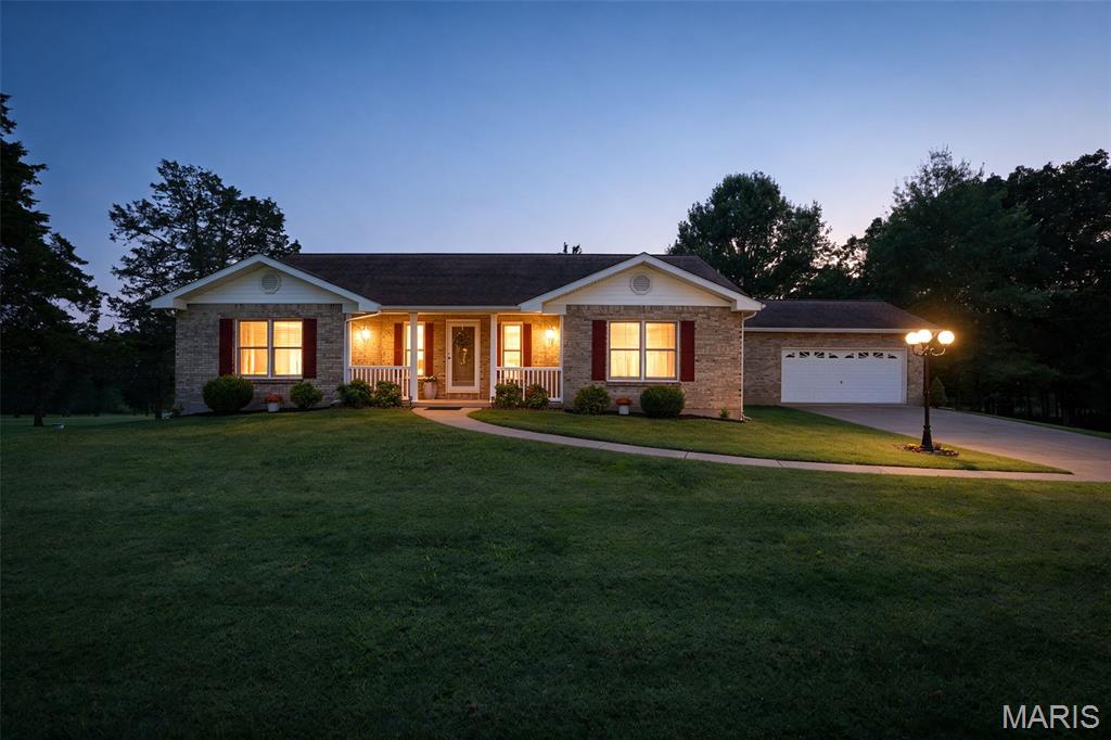 Welcome to 1390 Rue Riviera, a stunning brick home nestled in the desirable Terre Du Lac Lake Community! This spacious property offers 4 bedrooms and 3 full baths, combining comfort, style, and functionality.  The cathedral-ceiling living room with wood floors and an electric fireplace creates a cozy, open feel. The kitchen island and breakfast nook make entertaining effortless, while the main-floor laundry adds convenience.  Step outside to enjoy a large, covered deck and patio, perfect for relaxing or gatherings, overlooking a beautifully landscaped yard with a storage shed for extra space. The walk-out basement provides additional storage and future finishing potential.  Other highlights include a concrete driveway, 2-car garage, and access to 16 lakes, beaches, parks, and recreation areas—all part of the Terre Du Lac lifestyle!