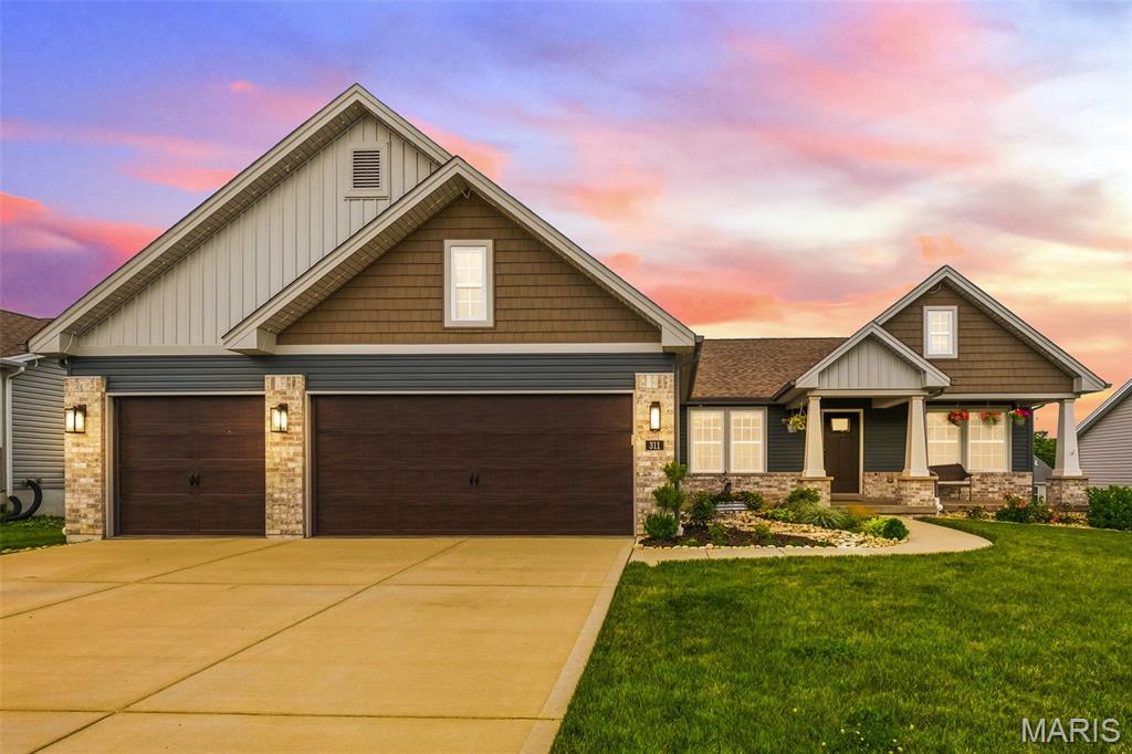 Experience luxury living in this stunning ranch home by Thomas Custom Homes located in sought after Carter Canyon and the Wright City School District. Just five years young and offering nearly 2700 square feet of living space, this 4 bedroom, 3 full bath home features an open floor plan with LVP flooring and vaulted ceilings throughout the main living areas. The gourmet kitchen showcases 42" cabinets with crown molding, granite countertops, center island, stainless steel appliances, double wall ovens, and a microwave drawer. The spacious primary suite includes a spa inspired bath with double vanities, an oversized shower with dual shower heads & benches, and a walk in closet. The finished walk out lower level adds a family room, recreation space, fourth bedroom, and full bath. Enjoy outdoor living on the deck overlooking the level fenced backyard. Complete with modern farmhouse curb appeal, a covered front porch, and a 3 car garage, this exceptional home offers the perfect blend of style, comfort, and quality craftsmanship.