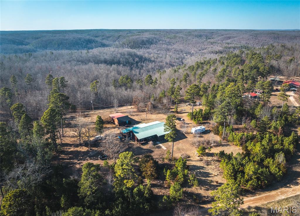 Escape to your own private retreat with this charming 3-bedroom, 2-bath cabin nestled on 20 secluded acres. Surrounded by nature and set well off the road, this property offers the perfect blend of comfort, recreation, and rural tranquility. Five acres are fenced around the home, making it ideal for pets, livestock, or simply enjoying a defined yard space. Inside, you’ll find a warm and inviting cabin feel with multiple heating options for year-round comfort, including a high-efficiency Trane heat pump, central air, two propane wall heaters, and a wood-burning stove for cozy backup heat. Whether you're looking for a full-time residence, weekend getaway, or hunting retreat, this property is ready to accommodate. A large workshop with electric provides excellent space for hobbies, storage, equipment, or projects. Outdoor enthusiasts will love the prime location near Big Creek Trail Ride, Montauk State Park, the Current River, and the Jacks Fork River. Enjoy endless activities such as canoeing, camping, fishing, hunting, horseback riding, and swimming. Wildlife is abundant, with deer and turkey frequently seen on the property, making it a true sportsman’s paradise. If you’ve been searching for privacy, acreage, and access to some of Missouri’s best outdoor recreation, this is the one.