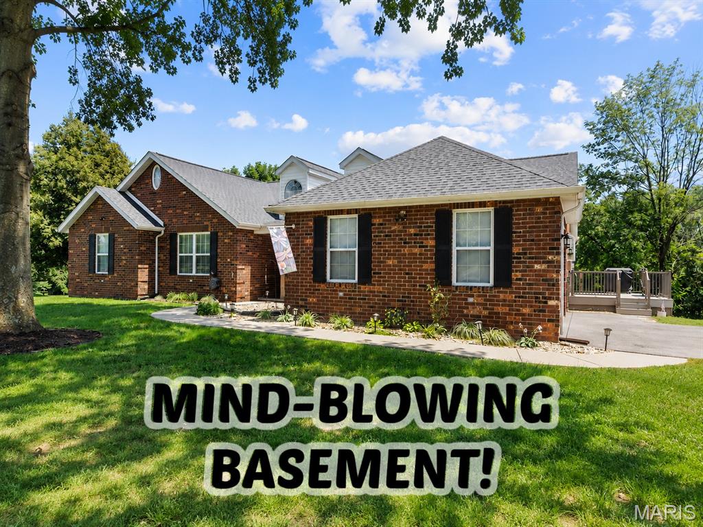 WOW! The feeling of small town unites with luxury entertainment space in this all-brick ranch on a finished walk-out basement in a lake community. This 4-bedroom, 3.5-bath home doesn't disappoint with 1.5 acres of semi-private space and an expansive backyard just waiting for a swimming pool. The main level grand entry welcomes to the comfortable and practical floor plan with all the bells and whistles you want. Cathedral ceilings accentuate the living room with brick fireplace and an adjacent sitting area to enjoy in the winter months. The open floor plan makes entertainment easy in the spacious kitchen with granite countertops, recently painted and updated hardware, pantry, and kitchen island. You'll love the sunroom just off the breakfast nook for morning coffee and tranquility. Formal dining space, plus a large home office tucked away so you can work in peace. Main level primary suite with a private deck and beautiful recent lighting and paint updates in the primary bathroom with double sinks, separate shower, and soaking tub. Guest bedrooms are sizable too. But the magic happens in the newly remodeled basement. This seller did extensive work and added to the overall square footage of this home. Easily entertain a large group of friends in the huge wet bar area with expansive cabinetry, bar fridges, and beer tap, plus plenty of counter space to host a gathering.  Family room with fireplace and easy access to the backyard makes this perfect for an additional entrance to accommodate a full living suite downstairs. This open area features a game room with a pool table, plus an extra area for flex space to make a home theatre or extra seating.  Large bedroom and brand new bathroom downstairs too.  Extra bonus: The best utility room you will ever see with custom elevated washer/dryer platform with room to store underneath, ample cabinetry, and folding area, or extra refrigerators, and more, and utility door access to the rear of the home.  Plus, extra unfinished storage space with shelving. Beautiful low maintenance concrete floor in basement.  Side entry garage, extra parking too.  New roof in 2024! Enjoy the lake benefits in this community too, whether it's fishing or just boating around, you'll love it!  Only 25 minutes to Scott Air Force Base. Schedule your tour today! Tons of extras too. Ask agent for details.