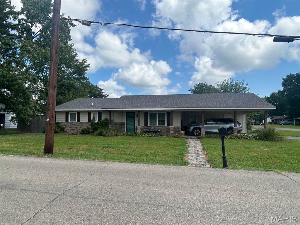 Here is your chance to own a move-in ready home near shopping in Dexter which is sitting on a corner lot with a fenced-back yard!  This home has had several updates in the past 8 years:  roof (2021), central heat and air units (2018), water heater (2025), new flooring (2024), and new sliding back door (2024).  The kitchen includes stainless steel appliances and an island in the center which adds additional work/storage space.  A small dining area is located in the kitchen area.  There is an entry from the carport to the dining area and a storage/mechanical area under the carport.  Step through that door and you will find the laundry room to the right.  Enter the front door to a living room large enough you could use part of it for a dining area if you choose.  Down the hall, you'll find three bedrooms, an updated bathroom, and a half-bath in the primary bedroom.  This home is ready for you!  Don't miss this opportunity, call today.