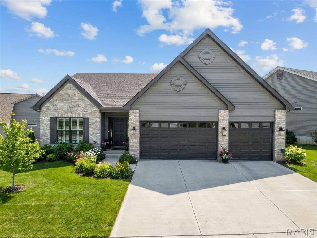 MOTIVATED SELLER!  An exceptional luxury detached villa distinguished by thoughtful design, extensive upgrades, and immediate availability at a value worthy of comparison to new construction. Just 1.5 years young, this meticulously maintained residence incorporates approximately $170,000 in premium builder upgrades, along with additional post-closing enhancements already completed. Positioned on a premium lot that allows for a 3-car oversized garage, a notable distinction within the community where most homes are limited to two, this residence offers enhanced functionality without sacrificing architectural harmony. The home features 3 bedrooms, 3 full baths, and a look-out lower level, all presented in pristine condition. The gourmet kitchen serves as the focal point of the home, appointed with refined white cabinetry featuring 42" upper cabinets with crown molding, rich granite countertops, a gas range, upgraded stainless steel appliances, under-cabinet lighting, an undermount sink, and an elegantly scaled 8' island with seating. The adjacent breakfast room opens to a covered, screened, maintenance-free deck, creating a seamless extension of the living space. The open great room, kitchen, and breakfast area are unified by 9' ceilings, carefully selected lighting and plumbing fixtures, black levered door hardware, and custom plantation shutters throughout, offering a timeless and elevated aesthetic. The primary suite provides a serene retreat, featuring an oversized tile-to-ceiling shower with frameless glass enclosure, adult-height double vanities with double sinks, marble-look LVT flooring, and a professionally designed walk-in closet system. A second main-level bedroom enjoys a full bath with equally refined finishes. The mostly finished lower level expands the living space with a generous family room, third bedroom, full bath, and abundant storage currently utilized as a hobby or workshop area, offering flexibility for guests, entertaining, or everyday living. Beyond original construction, the seller has fully drywalled and finished the garage, installed high-quality epoxy flooring, completed professional landscaping, and added a full irrigation system. All yards are fully sodded and maintained by the HOA, with snow removal also included, providing a truly carefree, lock-and-leave lifestyle. The community offers an appealing balance of convenience and natural beauty, featuring walking trails within a Certified Wildlife Habitat, two scenic ponds, and easy access to major highways and interstates, allowing effortless travel while preserving a tranquil residential setting. 
While similar selections may be available through new construction, this residence offers the advantage of having those choices already executed, refined, and absorbed in cost, presenting a sophisticated alternative for buyers who value immediacy, quality, and discretion.