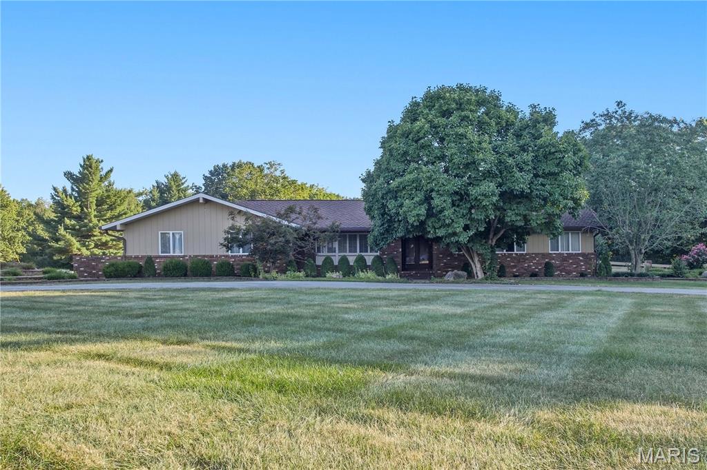 SNEAK PEEK!  Professional photos coming soon!  COUNTRY ESTATE that has been lovingly cared for by one-owner, perfectly combines private acreage with the convenience of living just minutes from town.  Situated on 10 scenic, partially wooded acres, this exceptionally well-maintained home offers 3 spacious bedrooms, 3 full bathrooms, and 1 half bathroom.  From the moment you arrive, you will notice the pride of ownership in the mature landscaping and the pristine care given to every corner of the property. The main living spaces flow effortlessly, providing comfort and functionality for everyday life.  Downstairs, the partially finished basement adds flexible living space, complete with an extra sleeping area that is perfect for hosting guests or setting up a private home office.  Outside, your personal oasis awaits with a pristine in-ground swimming pool surrounded by peaceful nature and mature trees.  Storage and workshop space are abundant with a 2-car attached garage plus an additional detached garage, making this home ideal for hobbyists, outdoor enthusiasts, or anyone seeking a peaceful retreat without sacrificing proximity to local amenities.  Kitchen appliances, washer, dryer, auto sweeper for pool, ping-pong table, pool table, and much more is included with the sale.  This one is a must see for yourself to believe it.  Call soon to set up your exclusive tour!