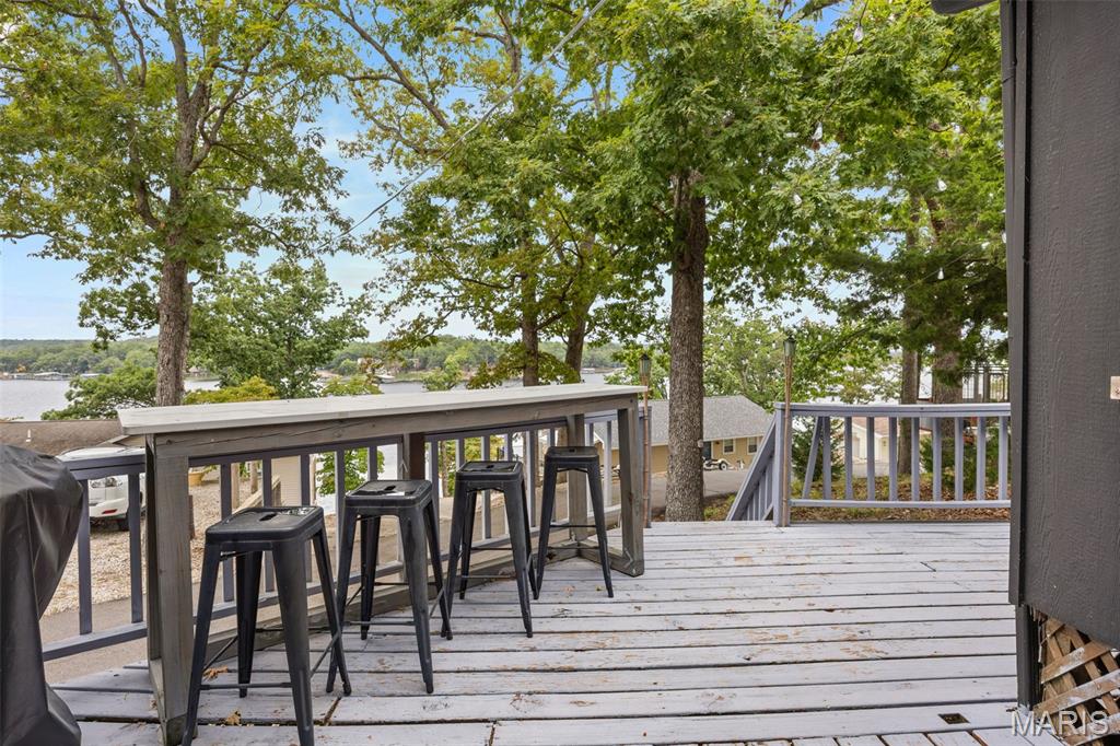 Rare turnkey at Lake of the Ozarks under $200k: lake cabin with a deeded 10x24 private boat slip and a profitable Airbnb track record. MM8 on the Niangua Arm — cove, easy water access, near public boat ramp. RENTAL PERFORMANCE (Sept '24–Aug '25): $34,544 Gross Revenue | $14,627 NOI | 68 stays | 175 nights booked | 47.9% occupancy | $197 ADR. Full P&L and booking ledgers available. THE PROPERTY: Open floor plan built around an iconic vintage Airstream — the unique retro design consistently drives 5-star reviews. Wraparound lake-view deck, LVP floors, tile-and-stone shower, fully furnished and stocked. ~100 ft walk from the back deck to the dock — fits a fishing boat, PWCs, kayaks, or canoes. LOW OPERATING COSTS: Taxes under $500/yr | HOA $300/yr. No boat lift or waterfront erosion to maintain. Cleaner and handyman vendor relationships already in place. CONVEYS WITH SALE: Fully turnkey — all furnishings, linens, kitchenware, decor. Includes the active "Funky Little Lakehouse" Airbnb brand with a year of established reviews, Blink security system, and detailed financials. Whether seeking a weekend retreat or a high-performing STR, this "ready-to-go" investment is a rare find.