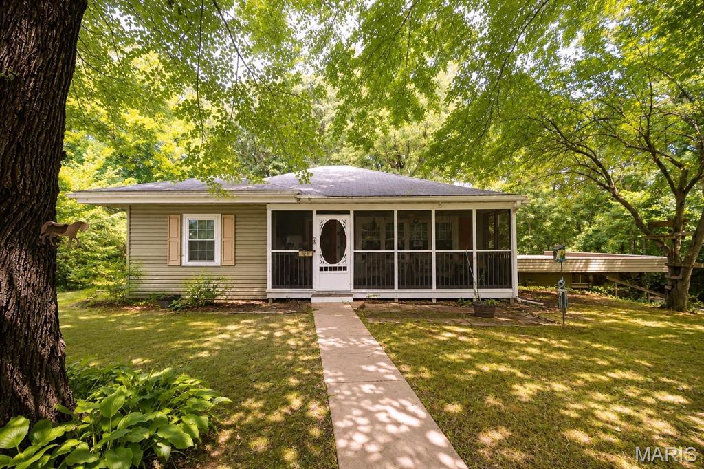 Nestled on nearly 2 acres, this charming 2-bedroom, 2-bath ranch offers the perfect blend of privacy and peaceful country living while remaining conveniently located. The backyard is fenced and backs to mature trees, creating a serene setting to relax or entertain from the spacious deck. Enjoy your morning coffee or unwind in the evenings on the screened-in front porch.

Inside, the home features comfortable one-level living with a partially finished basement that expands your living space. The second full bathroom is located in the basement, offering added convenience for guests or recreation areas. A 2-car tuck-under garage provides ample parking and storage.

Whether you're looking for a home to enjoy as-is or one where you can add your own personal touches over time, this property offers endless potential in a beautiful, private setting. Home is being sold as is. Seller will not provide occupancy, priced as such.