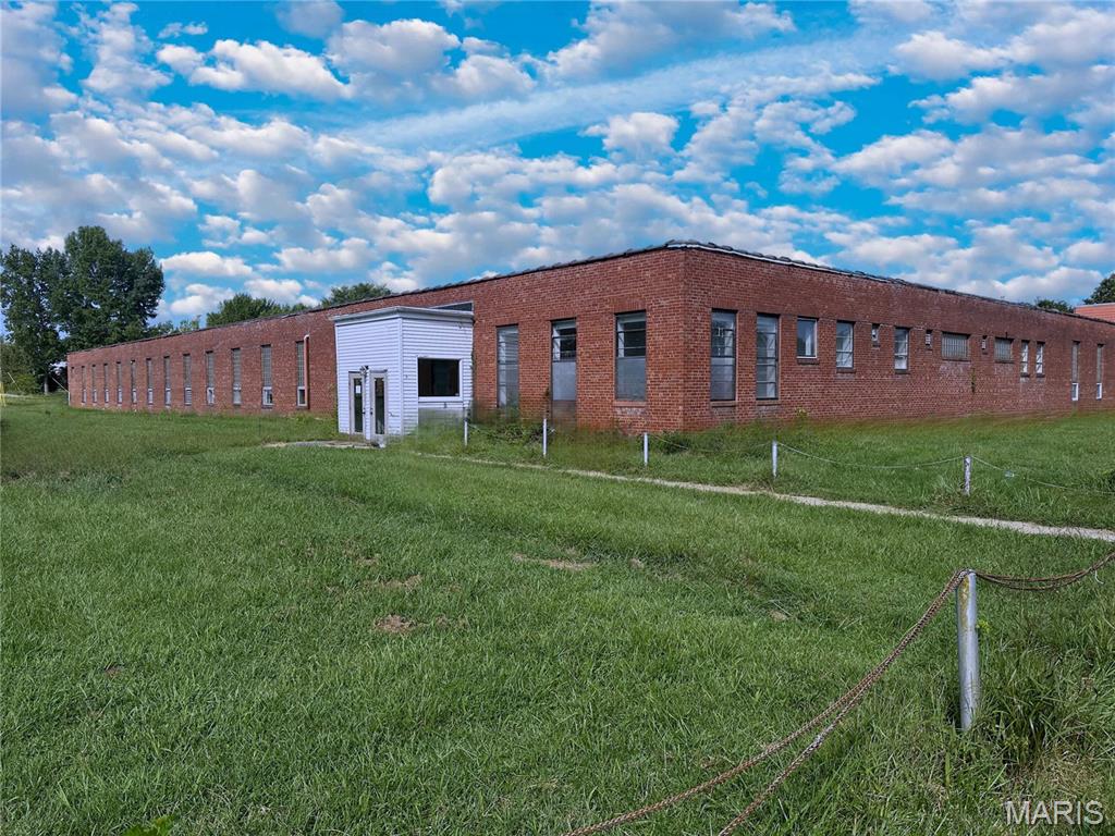 Spacious manufacturing or warehouse building located on corner lot in beautiful St. James, Missouri. Building sets on over 4 acres and boasts over 47,000 sq. feet of usable space, with one drive through door and three dock doors. Formerly used for cabinet and showcase manufacturing, the property is in the heart of Missouri with close access to I-44. Property has adequate electric and space for many different uses. Call to schedule a showing.