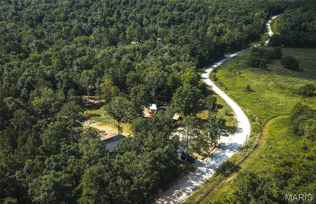 Escape to the beauty of the Ozarks with this charming 2-bedroom, 2-bath home, perfectly situated near the Mark Twain National Forest. Whether you're searching for a full-time residence, weekend getaway, or vacation rental, this property offers the ideal base for outdoor enthusiasts. Enjoy endless hunting, fishing, hiking, and ATV opportunities just minutes away. Inside, you'll find a warm and inviting rustic kitchen and dining area full of character, creating the perfect gathering space after a day outdoors. Step onto the covered deck and take in the peaceful views while enjoying your morning coffee or evening sunsets. Surrounded by nature and endless recreation, this property is your opportunity to experience the best of Ozark living.