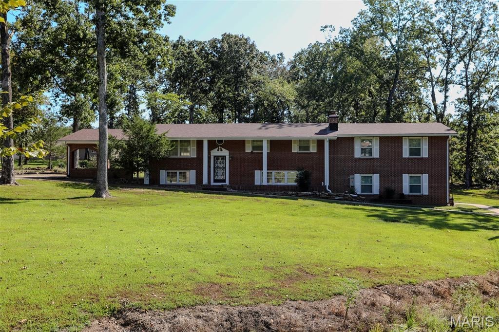 2706 Shady Lane, Poplar Bluff, MO- Tucked away on a quiet dead-end street in Poplar Bluff, 2706 Shady Lane is a meticulously maintained all-brick escape situated on approximately 2.66 shaded acres. The main level features three spacious bedrooms with generous closet space, anchored by a sprawling master suite complete with an impressive private bathroom. Thoughtful upgrades provide total peace of mind, including a brand-new roof and a new Generac whole-home generator. The lower level extends your living footprint with a second family room anchored by a cozy wood-burning fireplace, a fourth bedroom, and a versatile office or flex space. Capping off the lower level is a standout outdoor living area, perfect for relaxing or entertaining in complete backyard privacy. Combining low-maintenance brick construction, major mechanical upgrades, and prime private acreage, this property is a rare find and a great value.