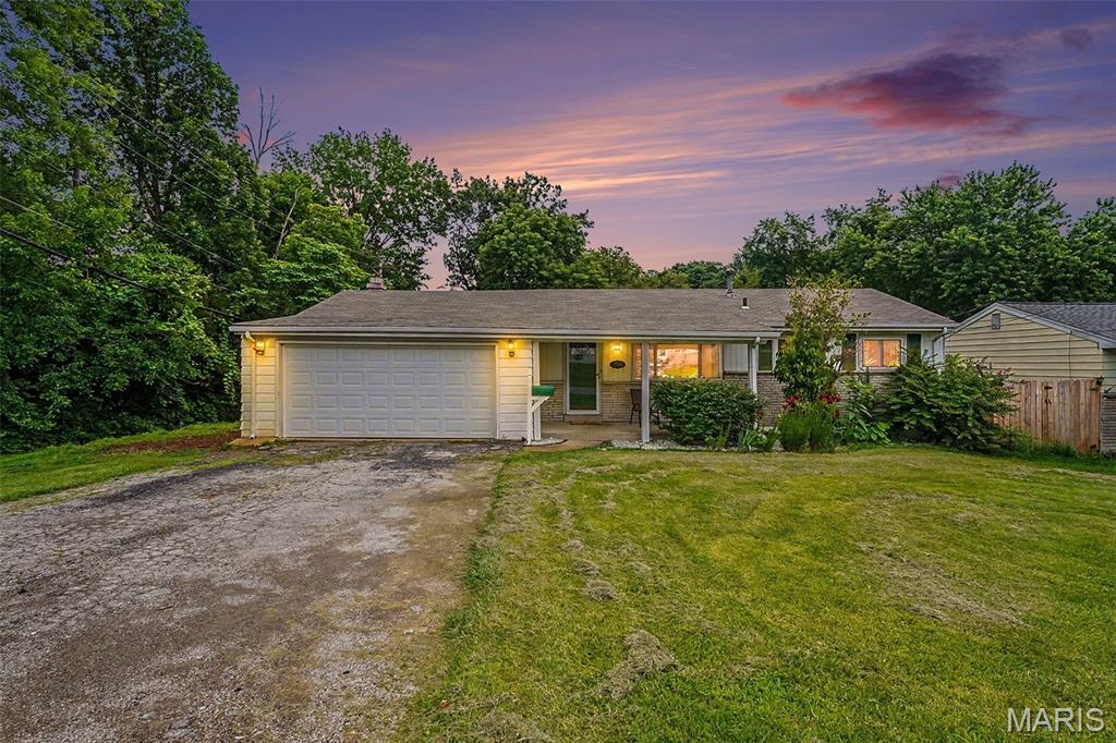 Welcome to 7800 Benmore Street, a charming ranch tucked at the end of a quiet street where comfort, character, and outdoor beauty come together. This 3-bedroom, 1-bath home offers 1,186 sq. ft. of inviting living space, a 2-car attached garage. The bright, updated kitchen is both cheerful and functional, featuring beautiful cabinetry, stainless steel appliances, and wood floors that continue through the bedrooms and dining room. At the heart of the home, the dining room exudes warmth and character with a wood-burning fireplace framed by built-in bookcases, creating the perfect setting for cozy dinners, holiday gatherings, or quiet evenings at home. Step outside and fall in love with the expansive fenced backyard, where fruit trees, grapevines, a fire pit, and play set create a truly special outdoor retreat. With common ground next door, a 2025 roof, and a nearby path leading to the Greenway Trail, this home offers a peaceful, park-like setting with room to relax, play, and enjoy the beauty of the outdoors.  An unfinished lower level ready for your vision. A sump pump installed in 2024 was added in preparation for a future second bath, offering a great head start for additional living space and equity potential.