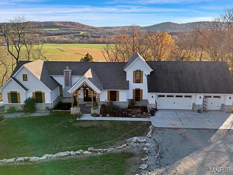 Welcome to your dream farmhouse retreat! This stunning 4 bedroom 4 bath home is nestled on an expansive 8.3 acres offering breathtaking views of the surrounding landscape and plenty of privacy. The exterior showcases charming natural wood shutters and elegant stone details that highlight the character of this beautiful property. Step inside to discover a spacious and inviting interior featuring a large kitchen with premium stainless steel appliances, a generous island and custom cabinetry that adds a touch of sophistication, while the expansive windows flood the space with natural light showcasing stunning views throughout. This home also boasts a full unfinished walk-out basement, providing endless opportunities for customization and additional living space. Prime location near wineries and surrounded by beautiful hiking trails! Don't miss the chance to make this exquisite property your own!