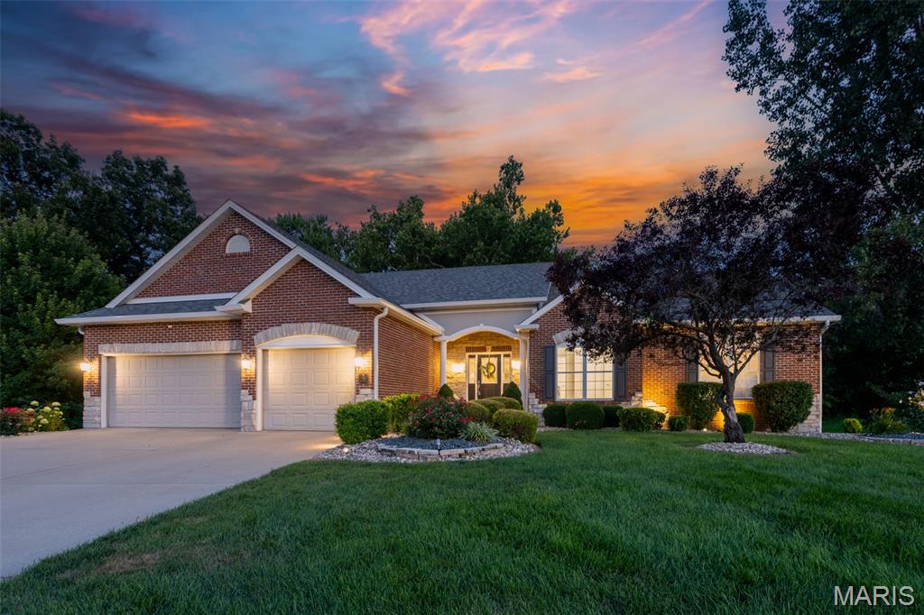 Impressive custom ranch tucked into the desirable Fountains of Sunset subdivision. Set at the end of a cul-de-sac and surrounded by a wooded setting, this spacious 5-bedroom, 5 bath home offers over 5000 square feet of finished living space designed for both everyday comfort and memorable entertaining.
The main level welcomes you with a generous living room that flows naturally into a chef-inspired kitchen, pantry, hearth room with fireplace, dining area and breakfast room. The primary suite with its vaulted ceiling, wall of windows and private deck access offers a spacious bath and walk-in closet, while two additional main-level bedrooms are connected by a Jack-and-Jill bath, creating a thoughtful layout for family or guests.
The walkout lower level expands the home’s possibilities with a large family and entertainment room, full kitchen and bar area, media-ready space, pool table area, two additional bedrooms or offices, two more bathrooms, and abundant storage. Outside, the fenced backyard provides room to relax, play, entertain, or add the outdoor living features you have always wanted. A 3-car garage, generous lot (two separate parcels, totaling almost an acre), and location near Sunset Hills Country Club, local conveniences, and access toward St. Louis make this Glen Carbon property a standout opportunity.
