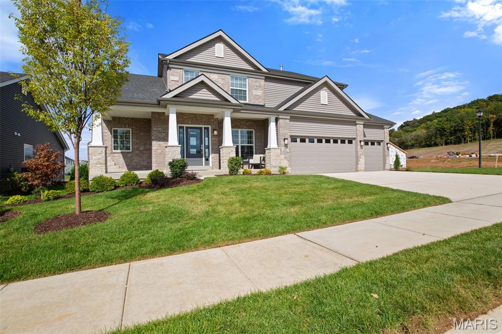 New McBride Homes Pin Oak 1.5-story luxury home with 4 BR, 3.5 BA, is ready now! DISPLAY HOME FOR SALE! Expanded floorplan w/3 CAR GARAGE! Enjoy a 2-story great room w/floor-to-ceiling window wall, 9’ ceilings, 6’ windows, & wood laminate flooring. The Gourmet kitchen features Winstead Burlap 42” cabinets, large island, quartz counters w/backsplash, GE stainless appliances, & double oven. Formal dining room & powder room included. Main-level primary suite w/walk-in closet & luxury bath w/ tub, shower, double vanities & water closet. Upstairs has a Jack & Jill bath between BRs 1 & 2, & a private bath for BR 3. Extras: dual-zone HVAC, spindled staircase, matte black fixtures, 2-panel doors, main floor laundry and more! Regal Pines offers beautiful new homes in Ellisville with convenient access to shopping, dining, parks, and major highways for easy commuting throughout St. Louis County. Enjoy peace of mind with McBride Homes’ 10 year builders warranty & incredible customer service! Similar photos shown.