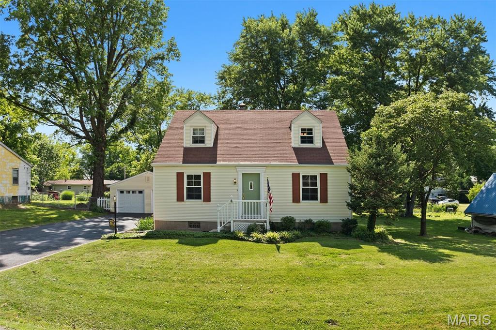 Charming two-story home on a double lot with a spacious detached garage! This inviting home features a bright living and dining room combo, perfect for entertaining. The well-appointed kitchen is ready for your next culinary adventure. The primary bedroom is conveniently located on the main floor, while upstairs you'll find two additional bedrooms and a full bath. The basement offers a versatile bonus room, a workshop, and a dedicated laundry area. Don't miss out on this fantastic opportunity!