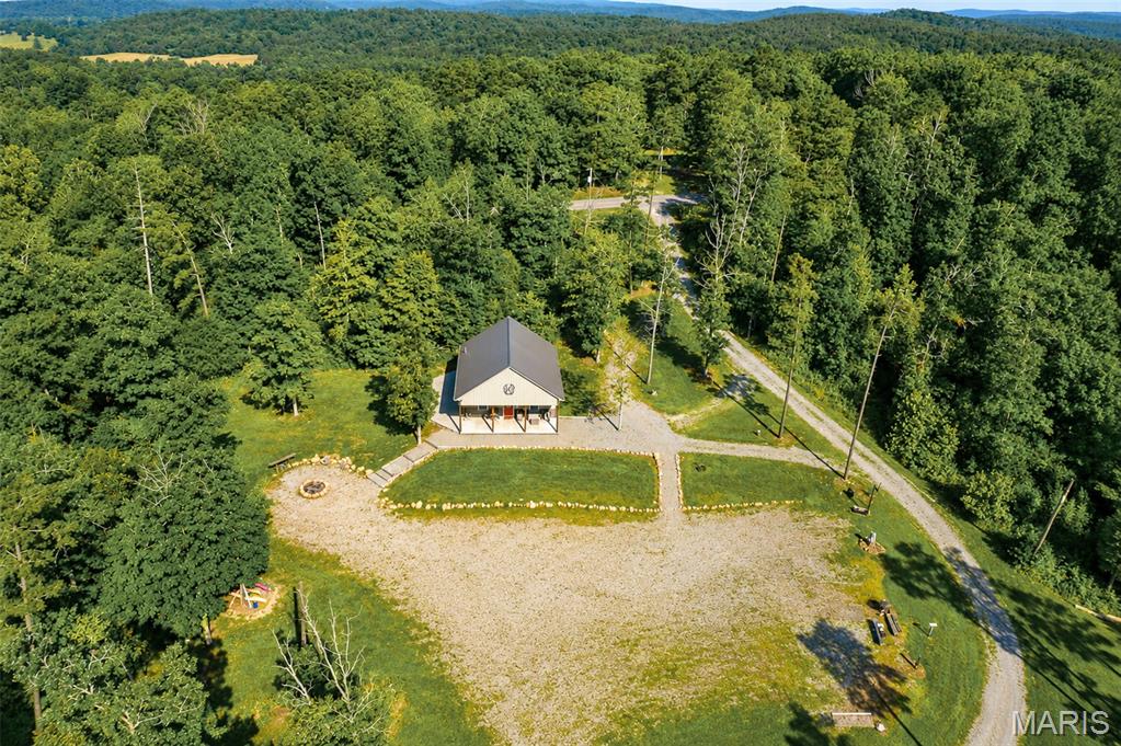 Welcome to the Saco Stay! The place where, within minutes, you can cool off in Twelve Mile Creek, float the St. Francis River while ripping lips on smallmouth bass and walleye, listen for turkeys from the porch, or chase whitetails on thousands of acres of nearby national forest. Is hiking your thing? Rock Pile Wilderness is right up the road.
This beautifully constructed cabin on 5 acres is the perfect retreat for the outdoor enthusiast. Designed for entertaining and hosting guests, it features an open living space with modern yet rustic finishes, five RV hookups, and a low-maintenance exterior. Enjoy the peace and quiet, or invite friends and ride SxSs for days—your next adventure could start here!
