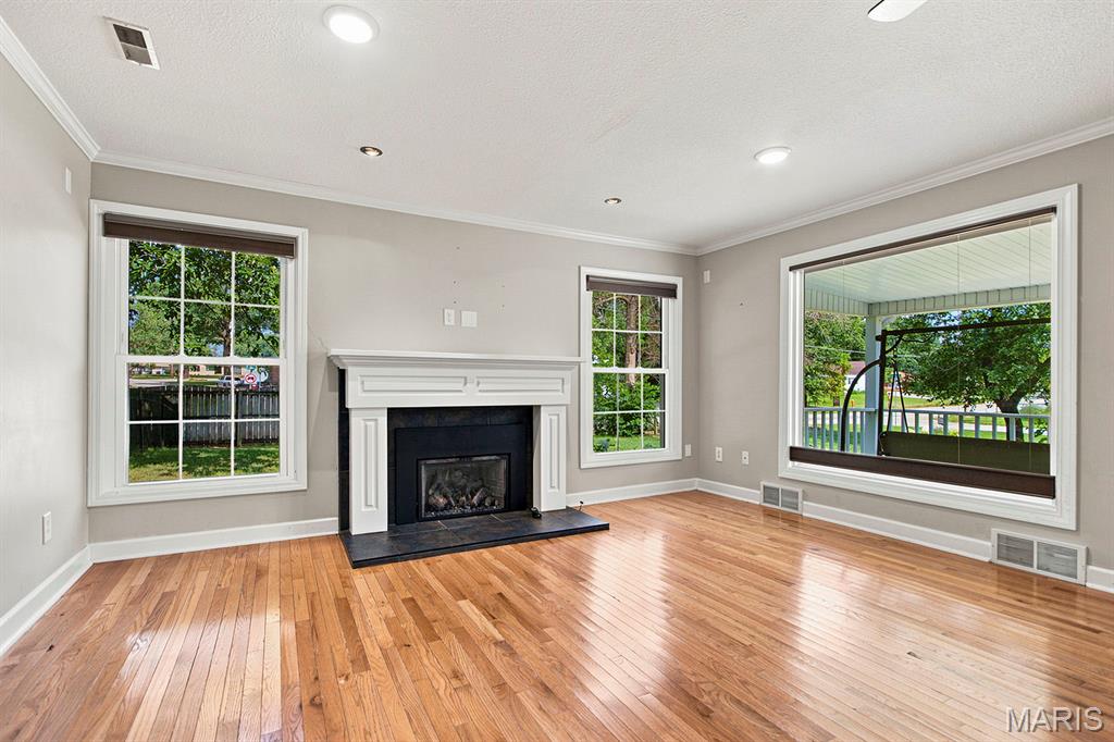 Spacious, stylish, and full of charm — this beautifully maintained 1.5-story ranch offers room for everyone inside and out! Featuring 3 bedrooms on the main level plus a private upper-level bedroom suite, this home combines functional living with warm, inviting spaces throughout.
Step inside to gorgeous hardwood floors flowing through the oversized living areas and bedrooms, highlighted by a stunning gas fireplace that creates the perfect gathering space. The large primary bedroom offers comfort and privacy, while the updated primary bath features double sinks and a walk-in shower. A separate dining room provides the ideal setting for family dinners or entertaining guests.
The kitchen offers abundant cabinetry, stainless steel appliances. Relax year-round in the bright 3-season porch overlooking the backyard retreat.
Outside, enjoy a mostly privacy-fenced backyard with mature trees, a basketball court, extra storage sheds, large deck space, and plenty of room to entertain, play, or unwind. Enjoy a peaceful setting with both open yard space and shade.
This move-in ready home offers the perfect combination of space, comfort, and outdoor enjoyment — all wrapped into one beautiful property!