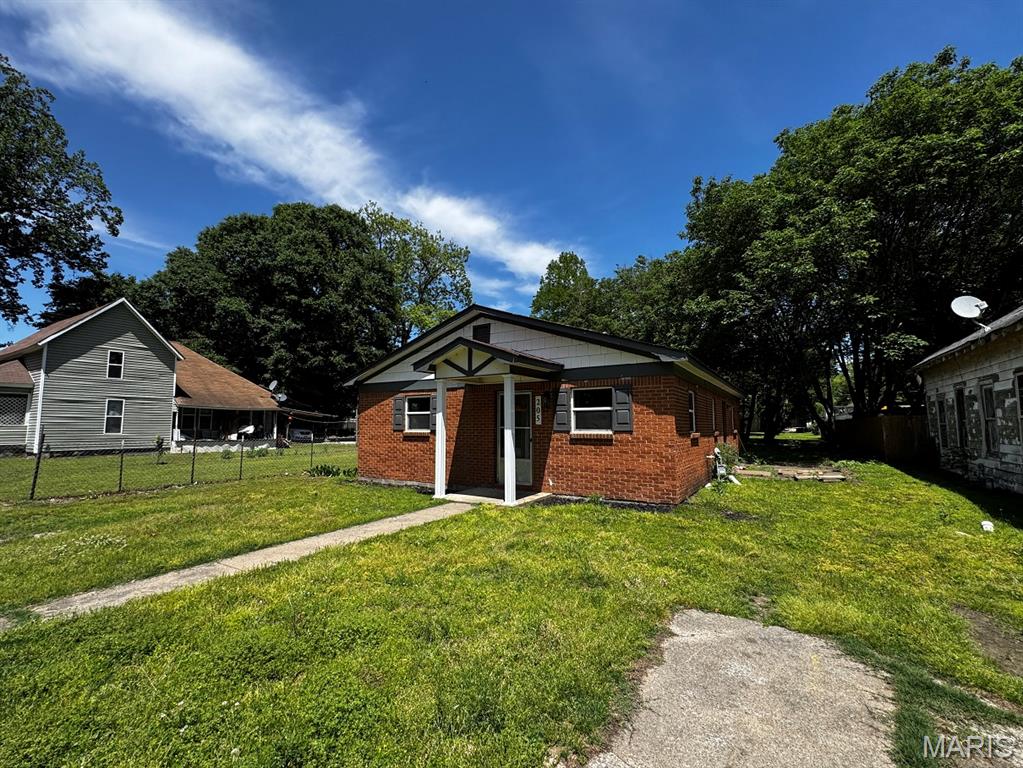 This is a 4-bedroom, 1.5 bath brick home with a nice-sized yard and an open floor plan.