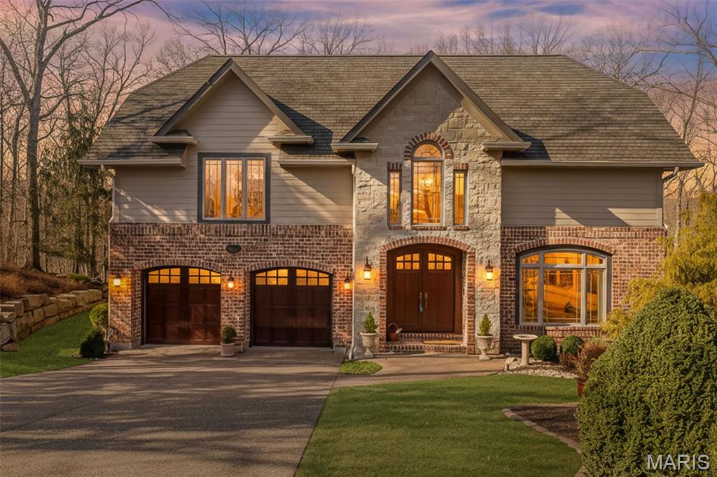 Everything inside and out combines to make this one of the finest homes you'll see. The elegant brick and stone facade leads to carfully crafted architectural details at every turn.  The interior boasts vaulted ceilings, exposed beams, 3 panel solid wood doors, an abundance of natural light. The kitchen is equipped with high-end appliances, including a Viking six-burner cooktop with an exhaust hood, built in refrigerator, double wall oven. The great room has beamed, vaulted ceilings, gas fireplace, built in cabinets, and light peaking in through windows high and low. Eastern white pine flooring extends throughout the home, complemented by truly elegant finishes, iron balusters, high celings, peekaboo windows. The primary bedroom provides a jet tub and walk in shower with multiple sprays and heads, large customized walk in closet. Each of the remaining three bedrooms is ensuite. The finished walk-out lower level adds flexible spaces for work in a quiet office space, relaxation and play in a bright family room,  and an inviting guest suite with full bath and walk in closet.. Outdoor living begins with a beautiful covered porch with a stone floor overlooking a carefully landscaped yard and acres of woods. Picture morning coffee and evenings of outdoor entertaining. Not only Hardie Board siding, but Hi Eff Lenox HVAC replaced is '23, Roof and gutters '23. Sprinkler System, rack system in garage.  2 adjacent lots comprise this 7 acres, lot
