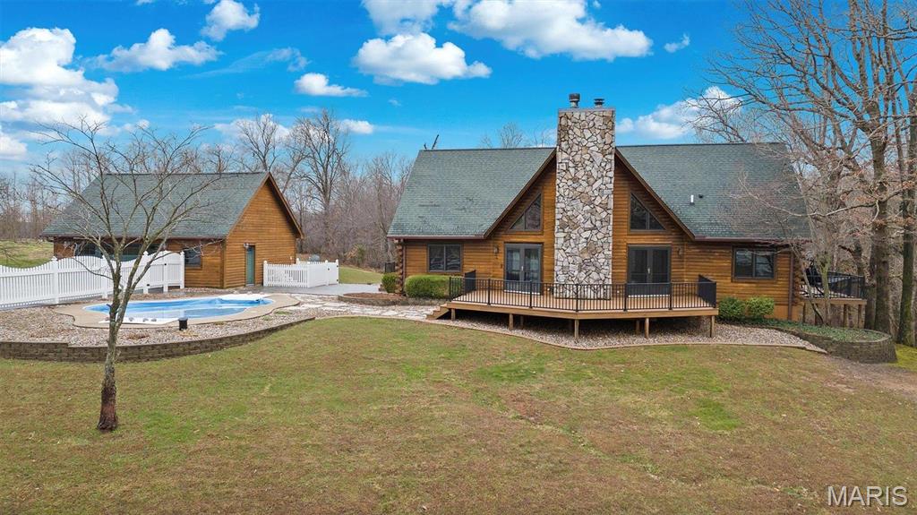 Dreams do come true! Imagine waking up every day in your beautiful log home, surrounded by nature and all these luxurious amenities! Whether you're playing a round of golf on your private 6-hole course with putting green, taking a refreshing dip in the pool, or enjoying time with your horses, this place has it all! The spacious layout has 4 bedrooms, 4.5 baths, open concept eat-in kitchen/living room has a vaulted ceiling with a stunning, large, stone fireplace. Additional features: upstairs loft and full- finished, walk out basement with rec room, family room,2nd fireplace and an office make it a perfect blend of comfort and elegance. Patios and decks surrounding most of the home offer outdoor space for entertaining and enjoying the outdoors! 2 car det. garage with bonus room, horse barn and trails for riding your ATV! Contents of the home are negotiable in the purchase price. What else could you ask for? Call today to see this piece of paradise on earth! Additional Rooms: Mud Room