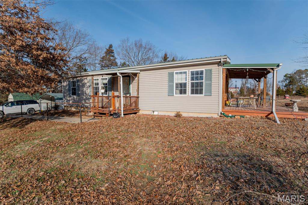 This manufactured home sits on 6.77 acres m/l with desirable blacktop road frontage, offering the perfect blend of space and country living. The home features three bedrooms and two full bathrooms with a functional layout and comfortable living areas. Outside, the property includes a carport, three sheds for storage or equipment, and a small pasture area ideal for animals or hobby farming. With open land and peaceful surroundings, this property provides plenty of room to enjoy rural living while still maintaining convenient access.