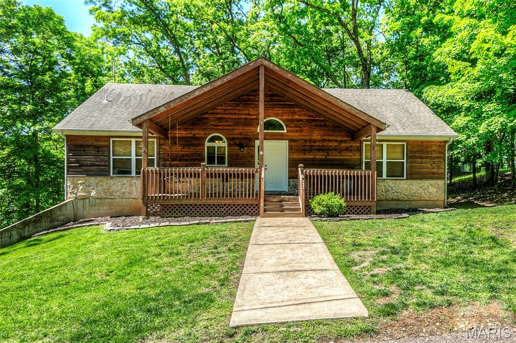 Welcome to 504 Greenwood in peaceful Lake Sherwood!  This cedar/stone facade (and vinyl sided) atrium-style ranch offers A LOT:  Split Bedroom 3BR/3.5BA/Main Floor Laundry/Fireplace/2+Car Garage/Fully Finished LL on beautiful wooded lot off the main drag.  Huge 26 x 8 covered front porch has soaring gable, lined with tongue & groove, plus a porch swing!  Hickory hardwoods through majority of main floor.  You will never tire of the wooded view from the back atrium wall of windows!  Open floor plan with huge vaulted Great Room, Dining Room, *bonus craft room/office,* and kitchen with SS appliances, pantry and access to separate laundry room.  Primary BR has full bath with double sinks, and walk-in closet with barn door. Secondary bedrooms share Jack & Jill bath, and there's another half bath for guests in the hall.  Totally finished LL with plenty of windows.  HUGE Recreation/Family Room with corner stone propane fireplace, large wetbar (refrigerator and wine fridge can stay), plus THIRD full bath.  Second *bonus area* here with a mud/storage room that is nicely finished and also has patio access.  There's another finished space that could be a craft area or more storage.  Access the delightful garage from the LL also -- 2+ car, oversized (690 sf/30x23), with heater and a/c unit, plus sink.  

Come enjoy resort-style living in Lake Sherwood!  Amenities include six lakes, sandy beach, marina, boat storage, pool, clubhouse, adjacent George H. Schmidt Park ballfields, walking trails, and more!  Gated community with secure entry.